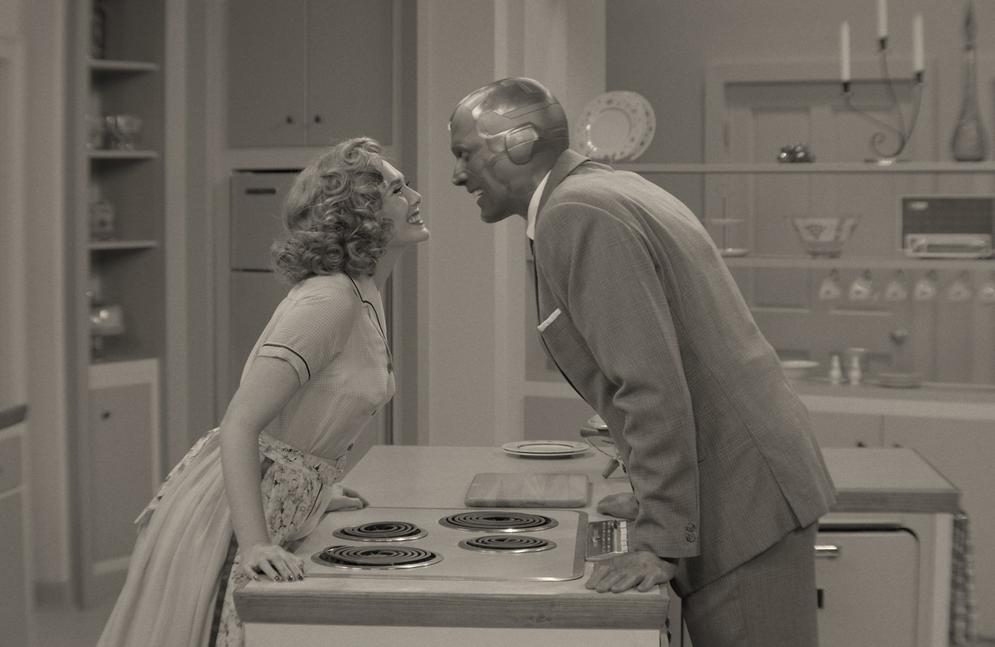A black-and-white image of the 'WandaVision' premiere. Elizabeth Olsen's Wanda and Paul Bettany's Vision are leaning over a counter and look like they're about to kiss. Will 'WandaVision' take home any Emmys?