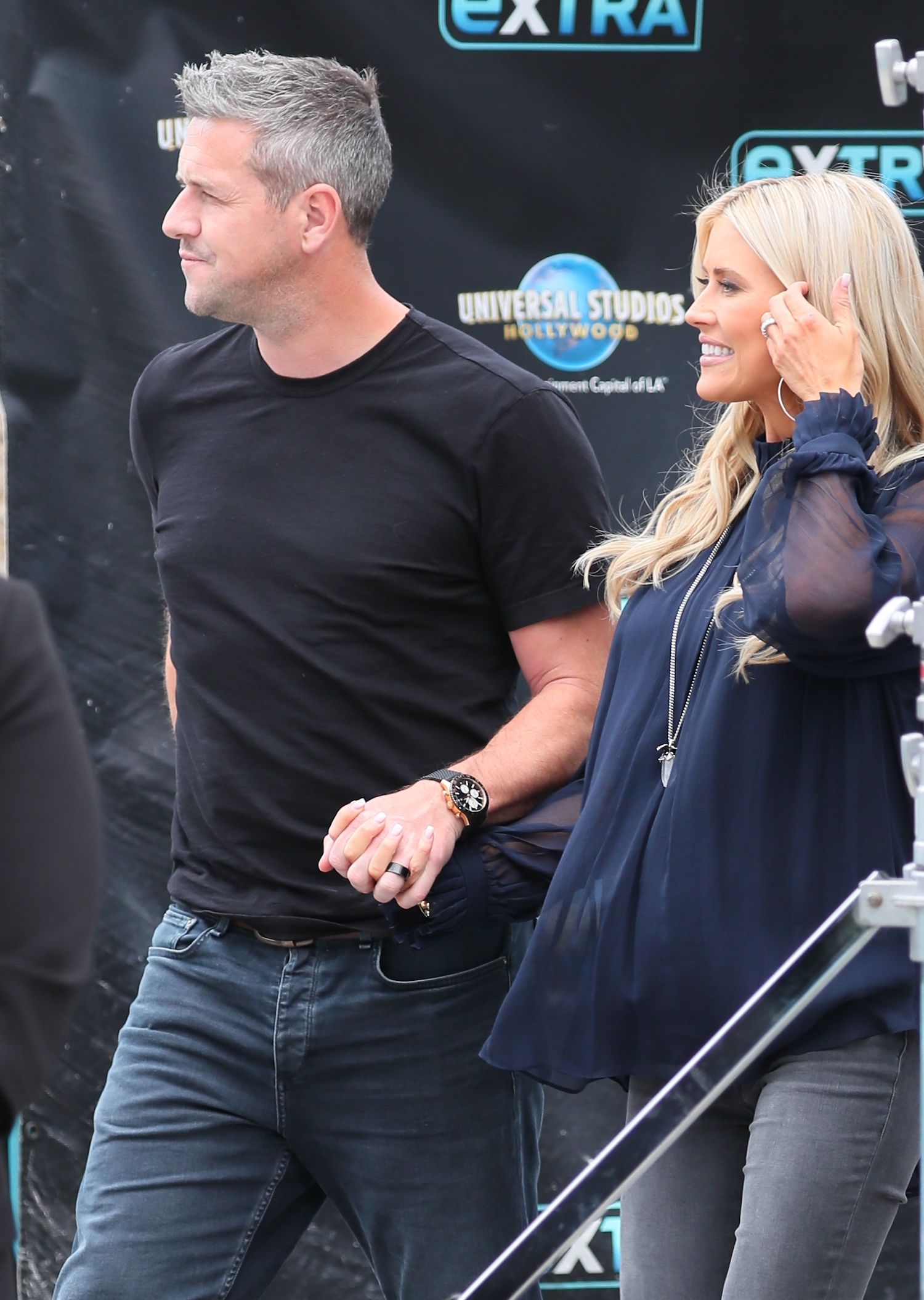 Ant Anstead and Christina Haack holding hands and walking onto the 'Extra' set in 2019