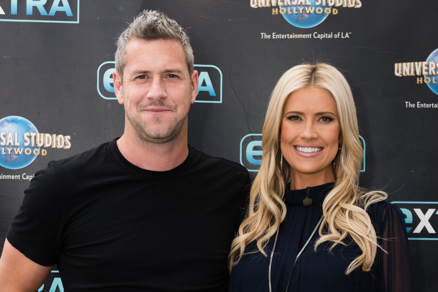 Ant Anstead smiling, poses next to Christina Haack who is smiling wide