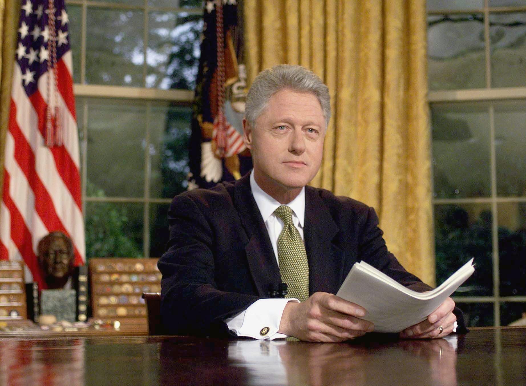 President Bill Clinton holding papers