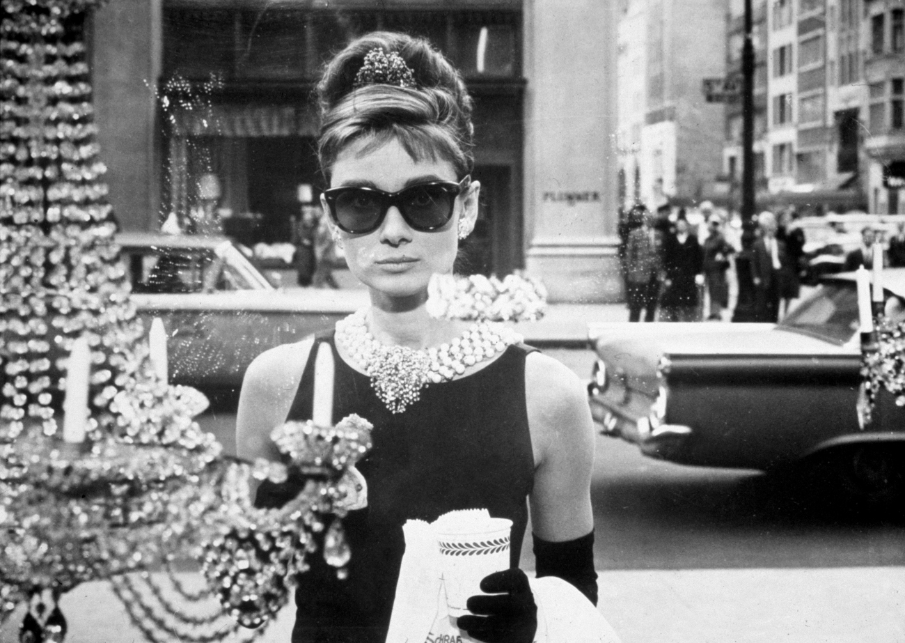 Audrey Hepburn as Holly Golightly holding a coffee cup in 'Breakfast at Tiffany's'