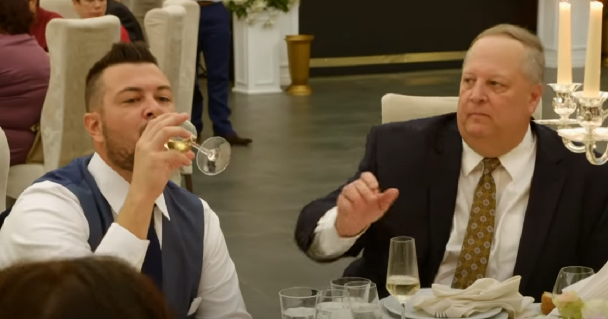 Charlie Potthast drinking at Libby and Andrei's wedding -- Chuck Potthast looks on, concerned