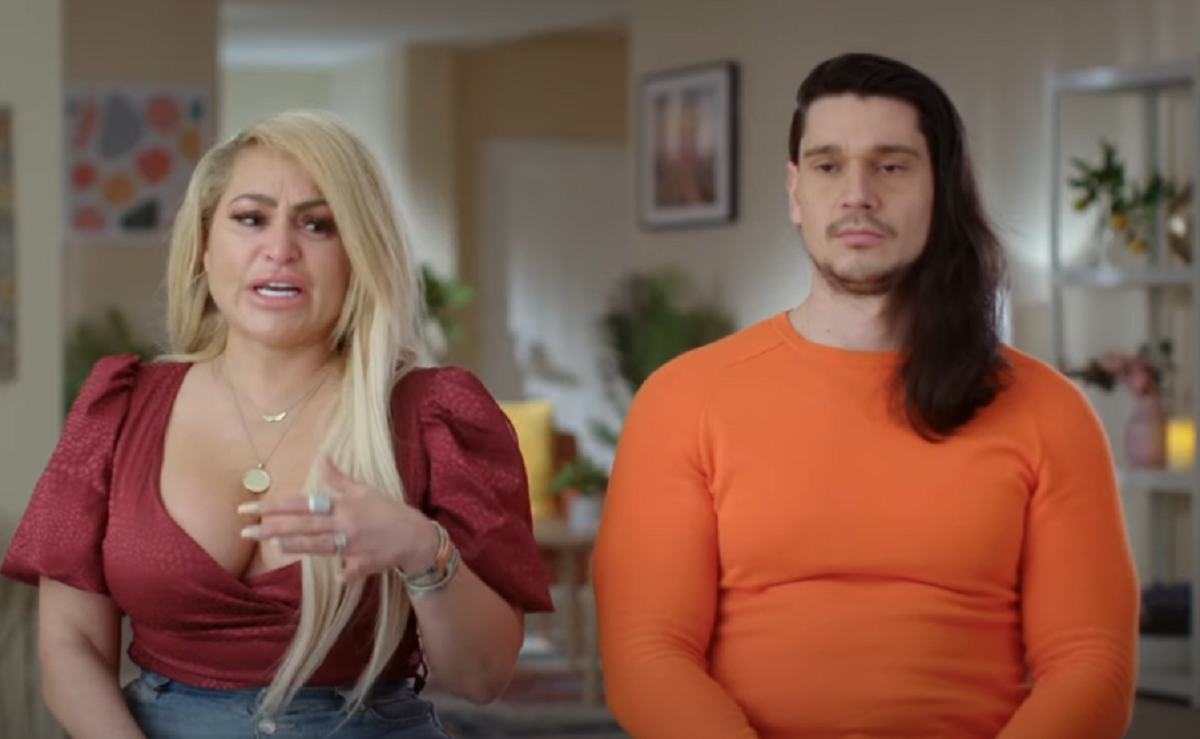 Darcey Silva and Georgi Rusev on 'Darcey & Stacey' -- Are Darcey and Georgi still together? The two face the camera, Darcey talking and visibly upset in a red top, Georgi looking blank in an orange shirt.
