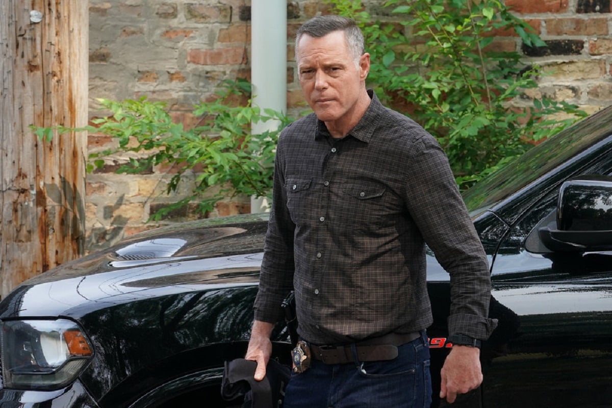 Jason Beghe as Hank Voight on Chicago P.D. Season 9 -- Voight wears a button down and jeans, and squints into the camera.