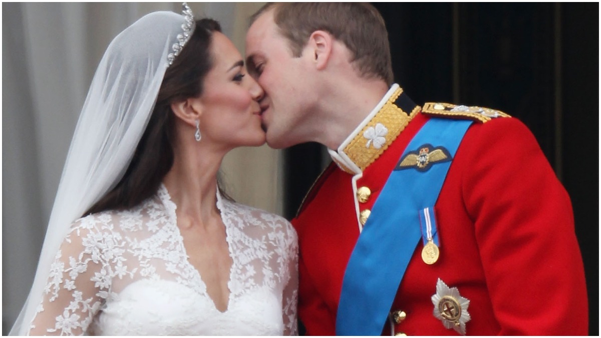 Kate Middleton and Prince William kiss on the Buckingham Palace balcony during their wedding day.