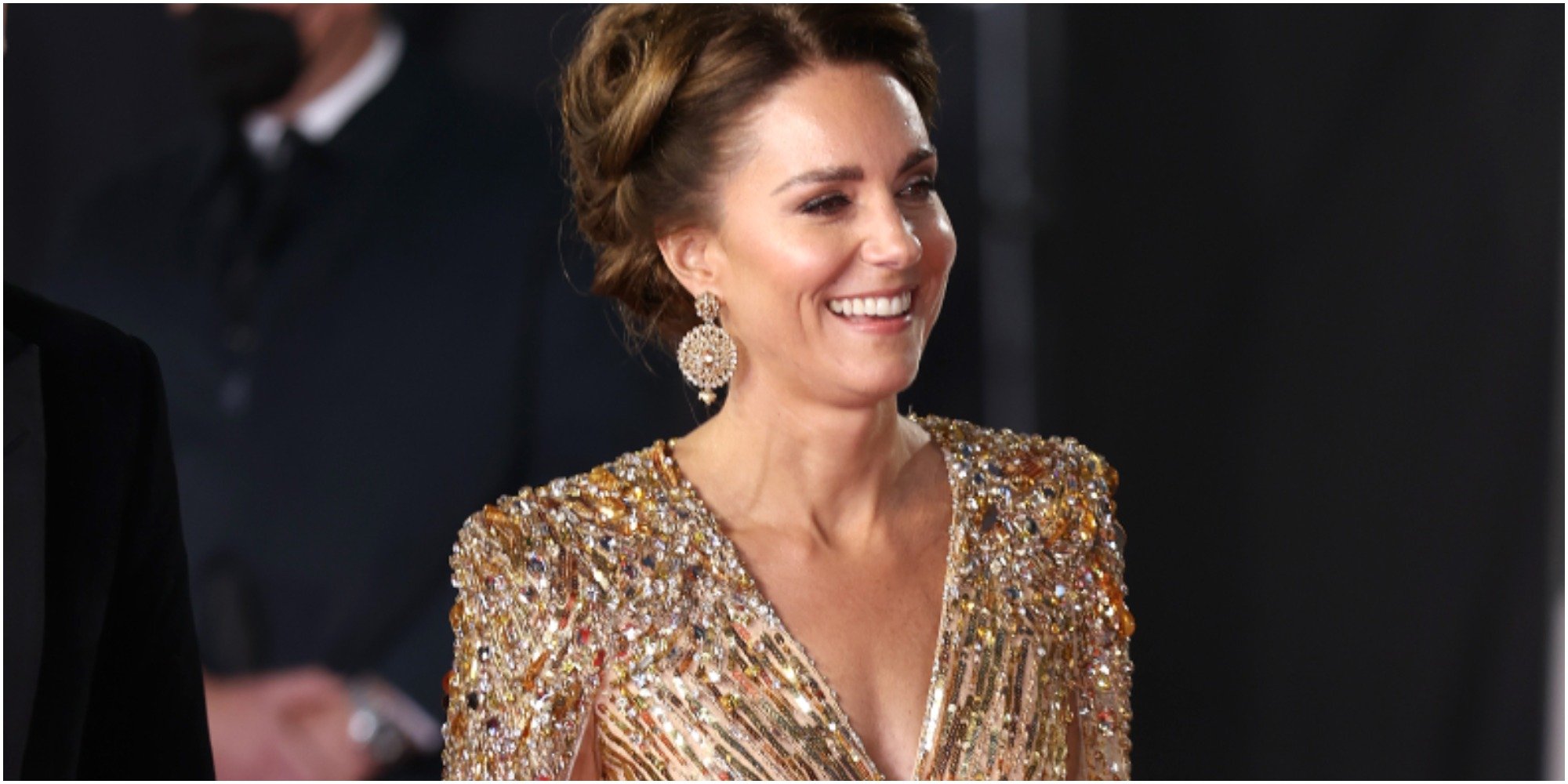 Kate Middleton wears updo and glittering gold dress to No Time to Die premiere.