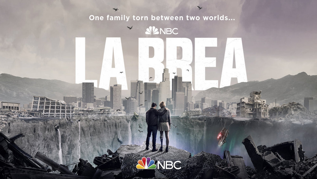 New NBC sci-fi/drama 'La Brea' key art of two people looking out over a giant sinkhole that's appeared in Los Angeles.