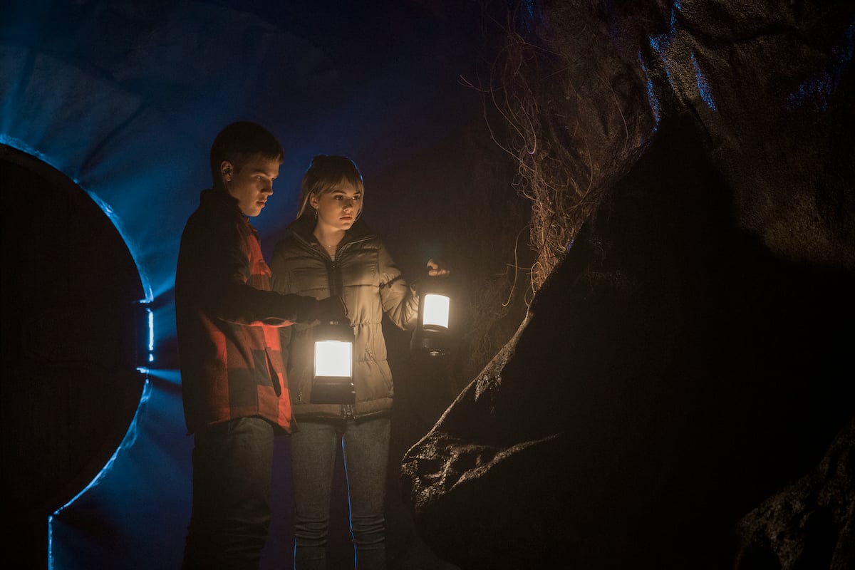 Tyler (Connor Jessup) and Kinsey (Emilia Jones) explore a cave in a production still from 'Locke & Key' Season 1.