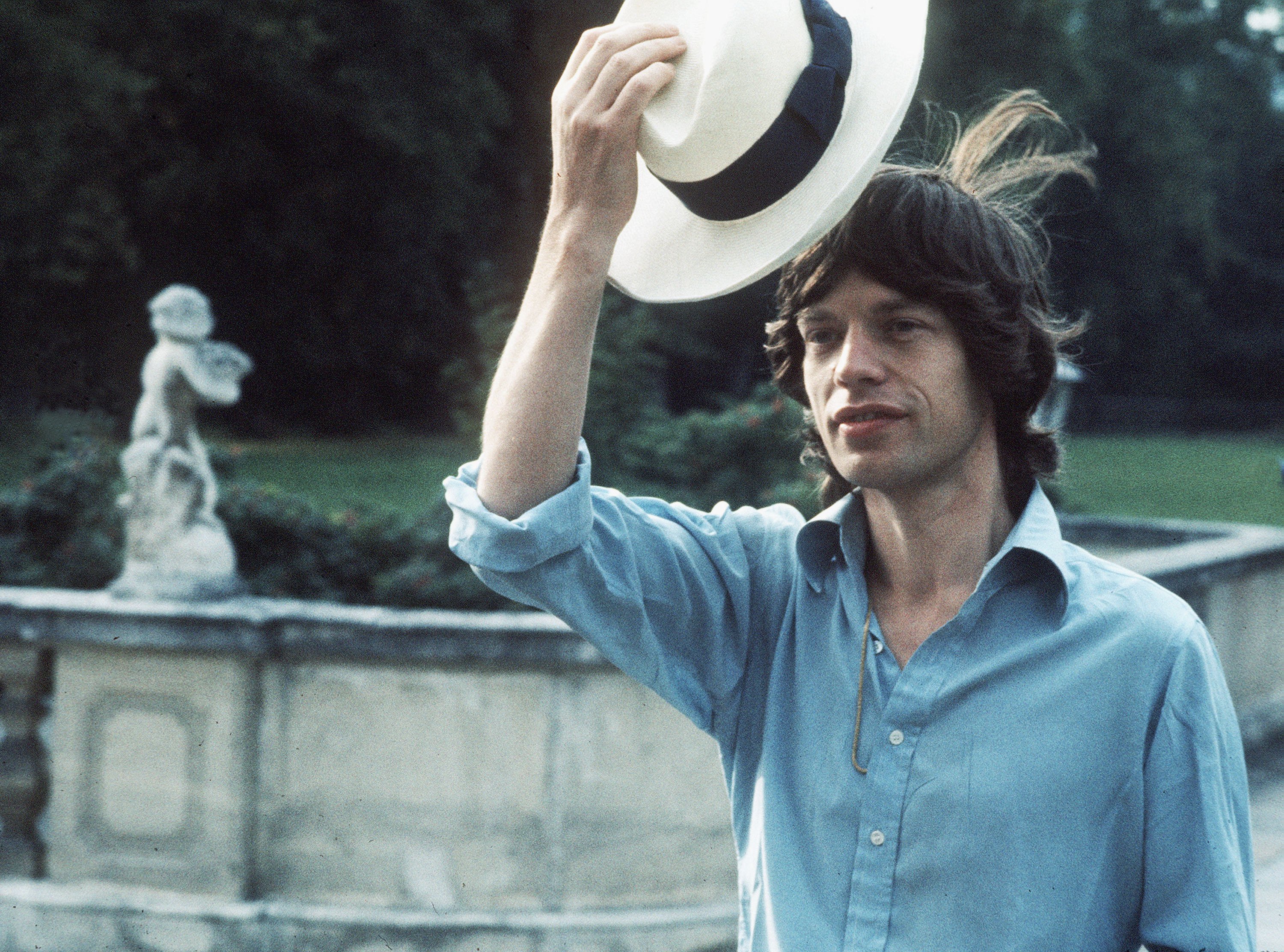 The Rolling Stones' Mick Jagger holding a hat