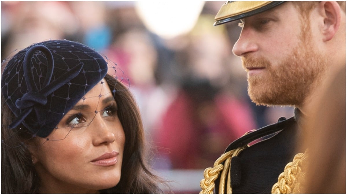 Meghan Markle and Prince Harry look at one another in a photo taken at a royal event.