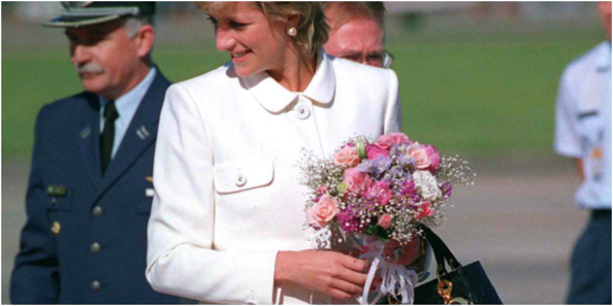 Princess Diana carries her favorite Dior bag in a press photograph.