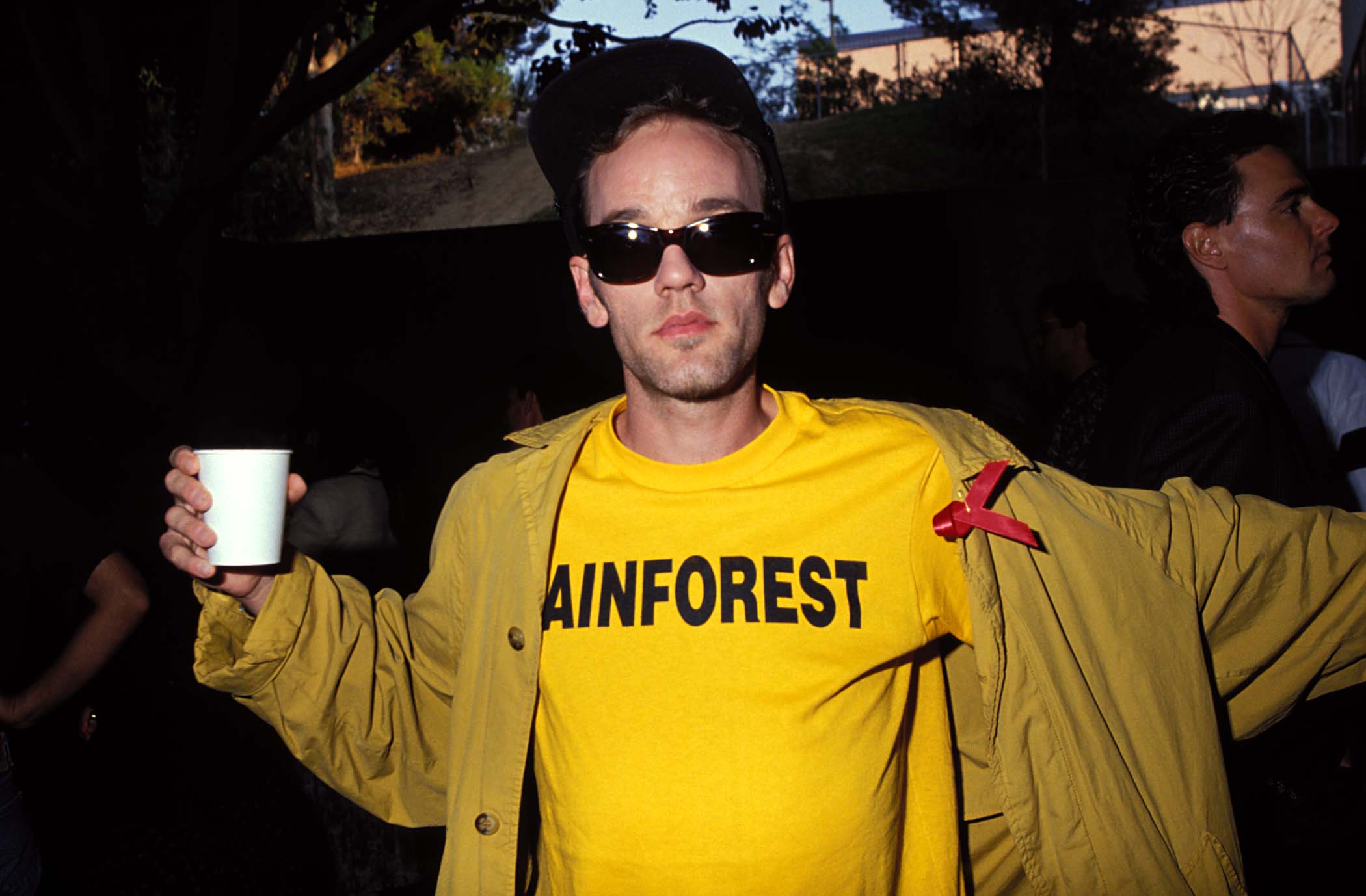 R.E.M.'S Michael Stipe wearing a yellow shirt and a hat