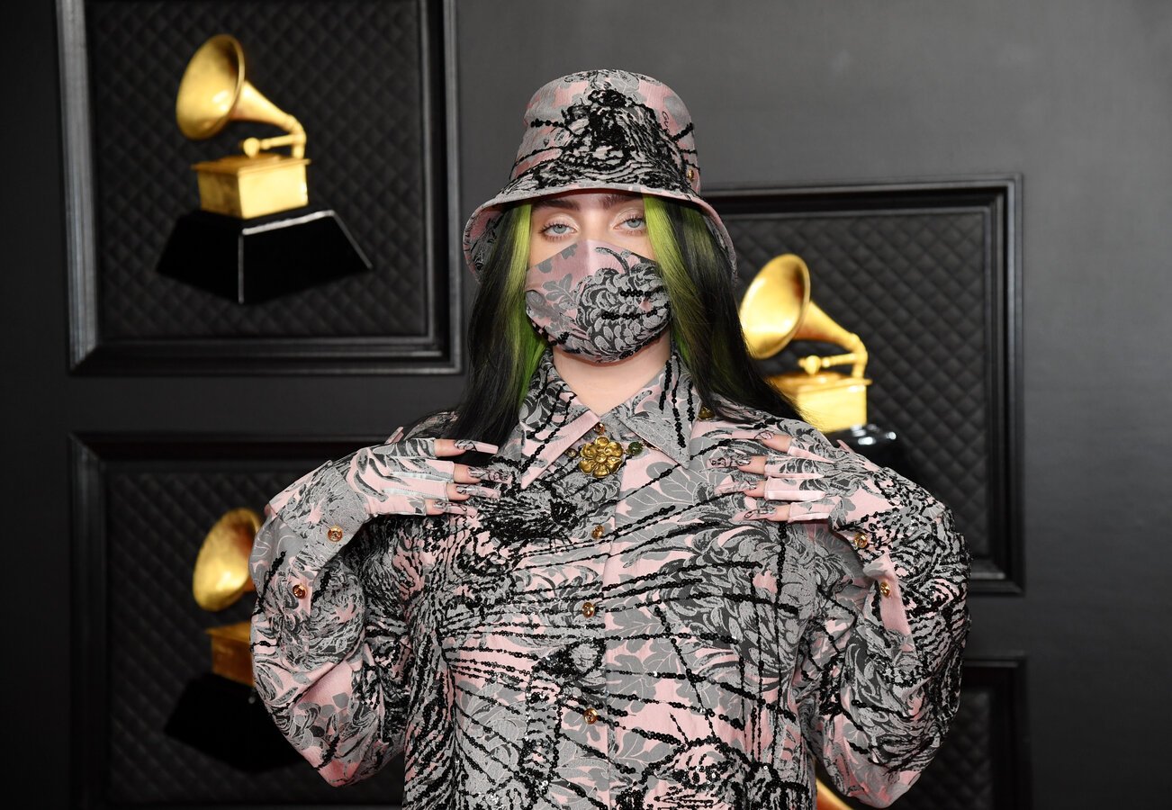 Billie Eilish at the GRAMMY Awards in a matching hat, mask, and outfit.