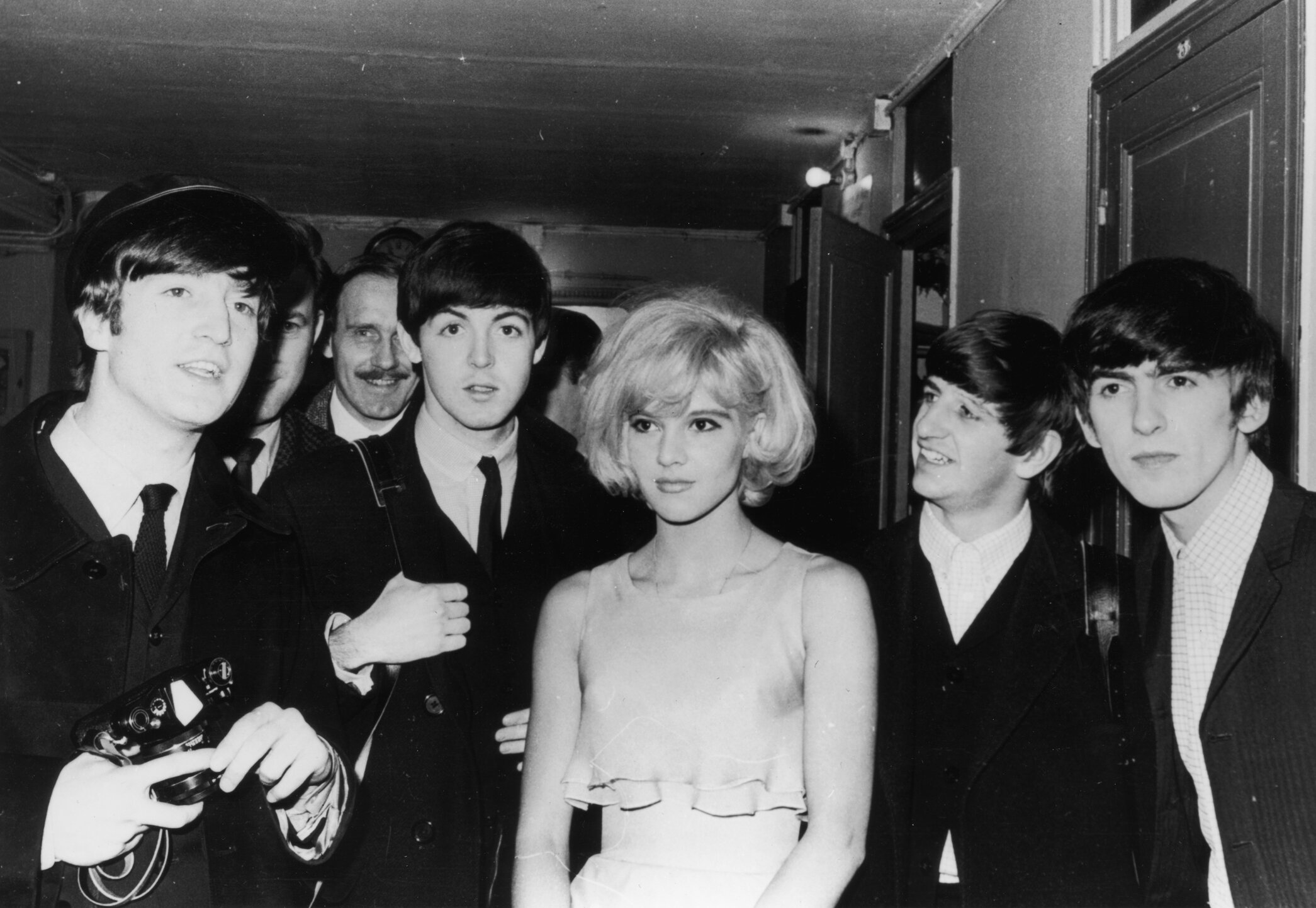 The British pop band The Beatles, left to right, John Lennon, Paul McCartney, Ringo Starr, and George Harrison, after their Paris show in 1964 with their co-star, the French singer Sylvie Vartan.
