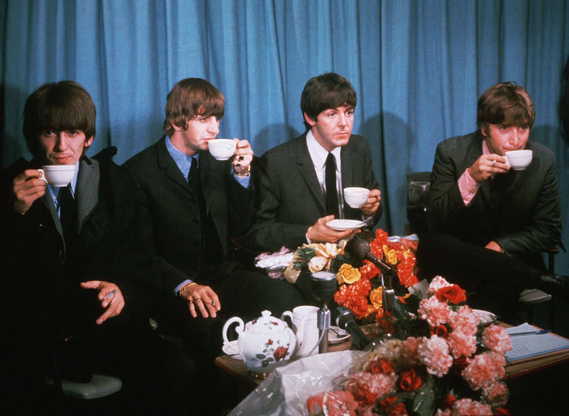 The Beatles drinking tea (L-R) George Harrison, Ringo Starr, Paul McCartney, John Lennon.