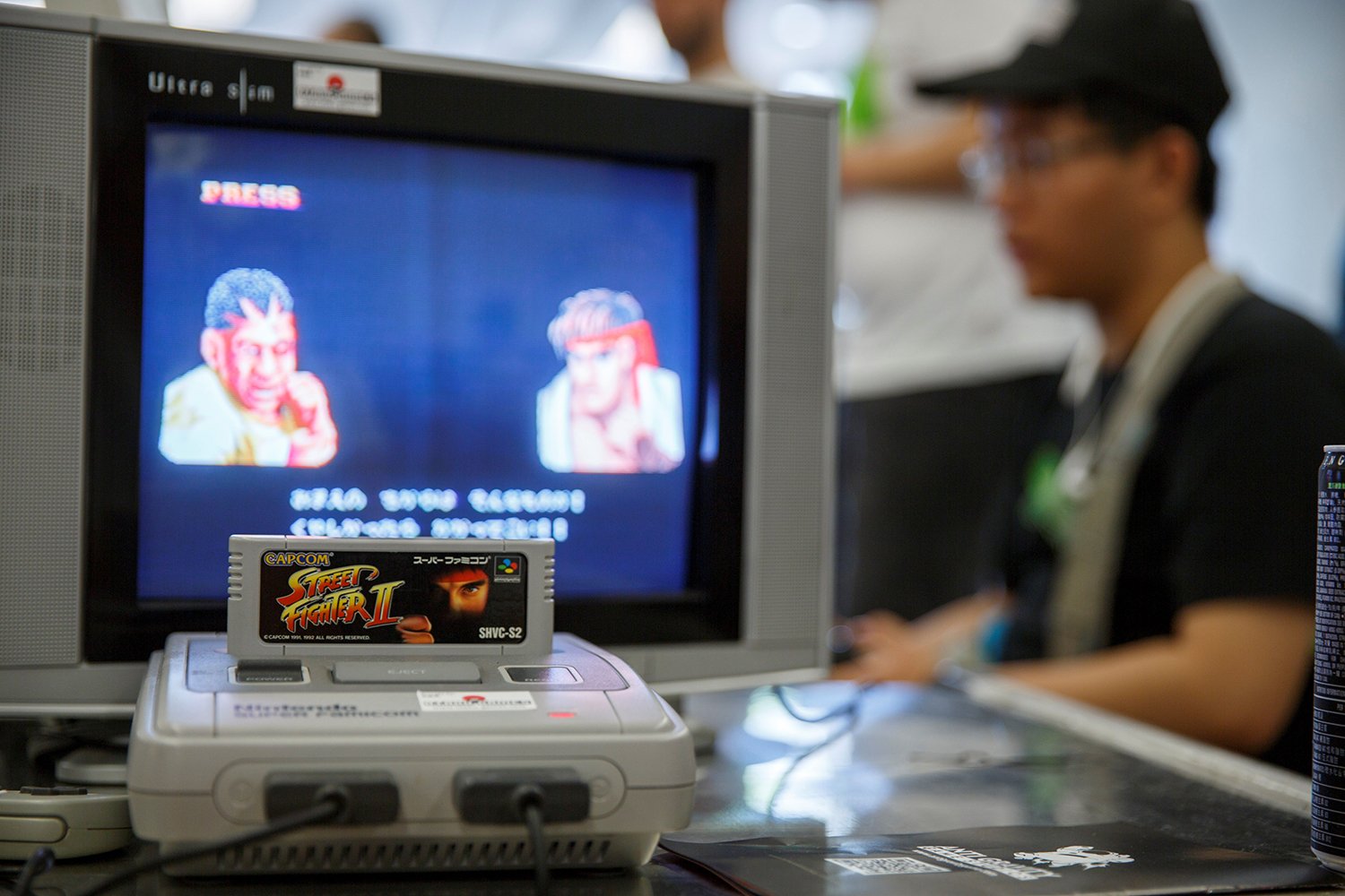 A Nintendo Entertainment System runs Street Fighter II, with cover art designed by Mick McGinty