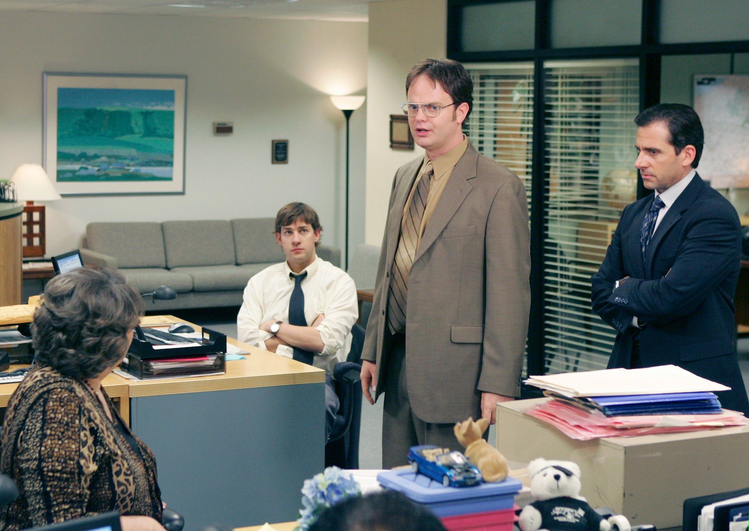 'The Office' actors in character at Dunder Mifflin. John Krasinski as Jim Halpert, Rainn Wilson as Dwight Schrute, and Steve Carell as Michael Scott.