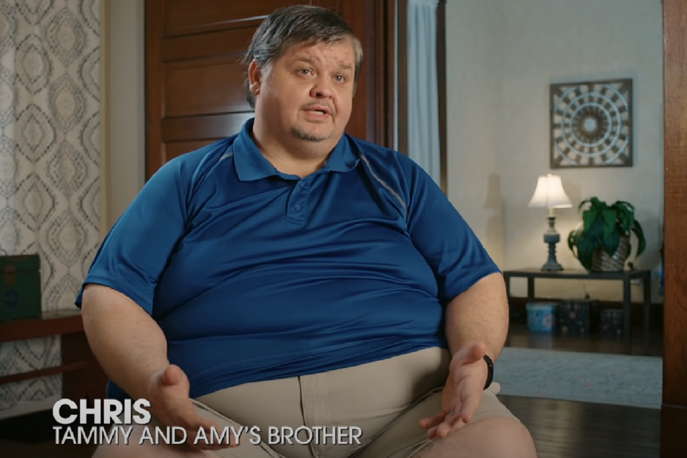 '1000-Lb Sisters' Season 3 star Chris Combs -- Chris Combs wears a blue polo and talks to the camera while seated.