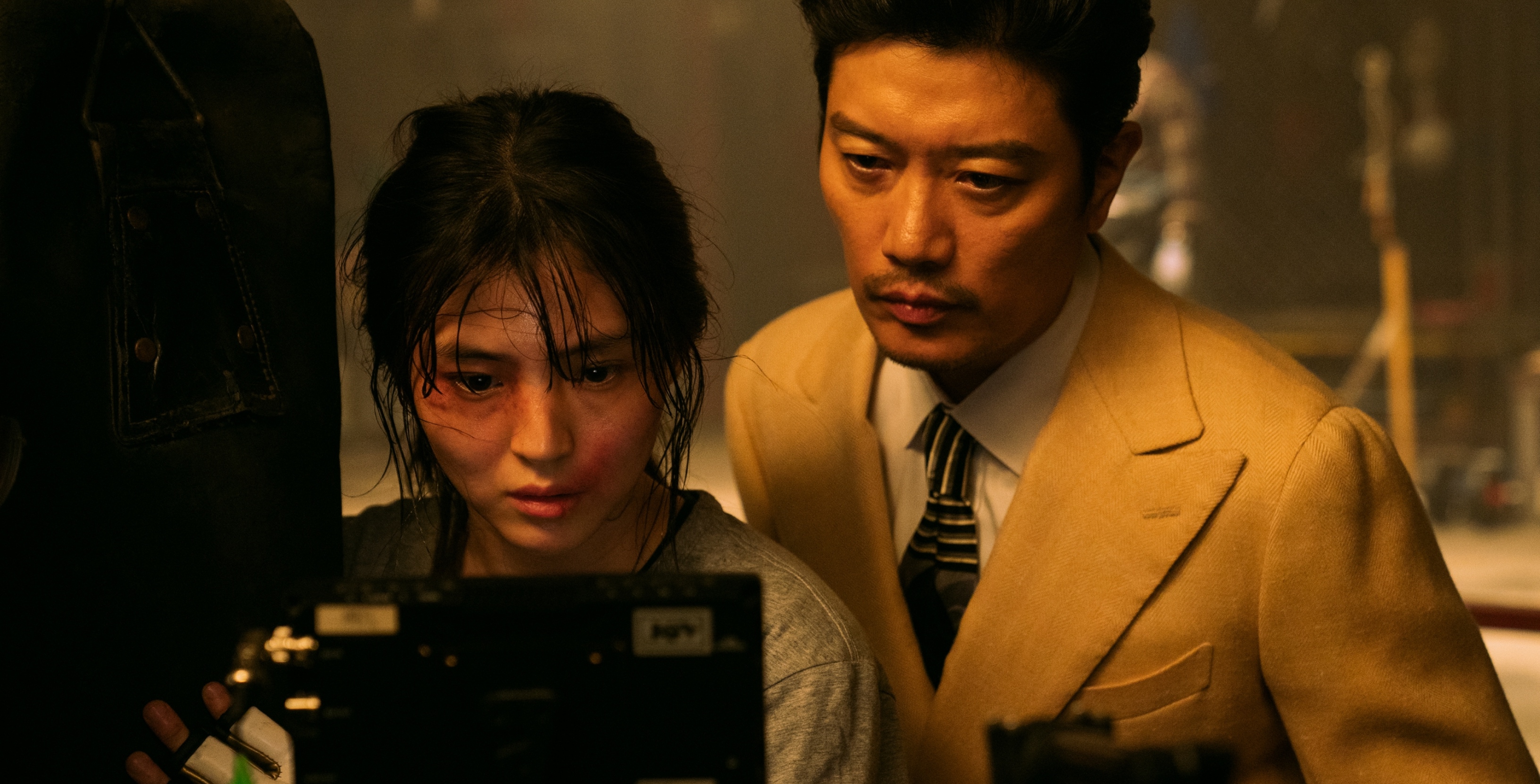 Actors Han So-Hee and Park Hie-soon behind the scenes of 'My Name' looking at monitor