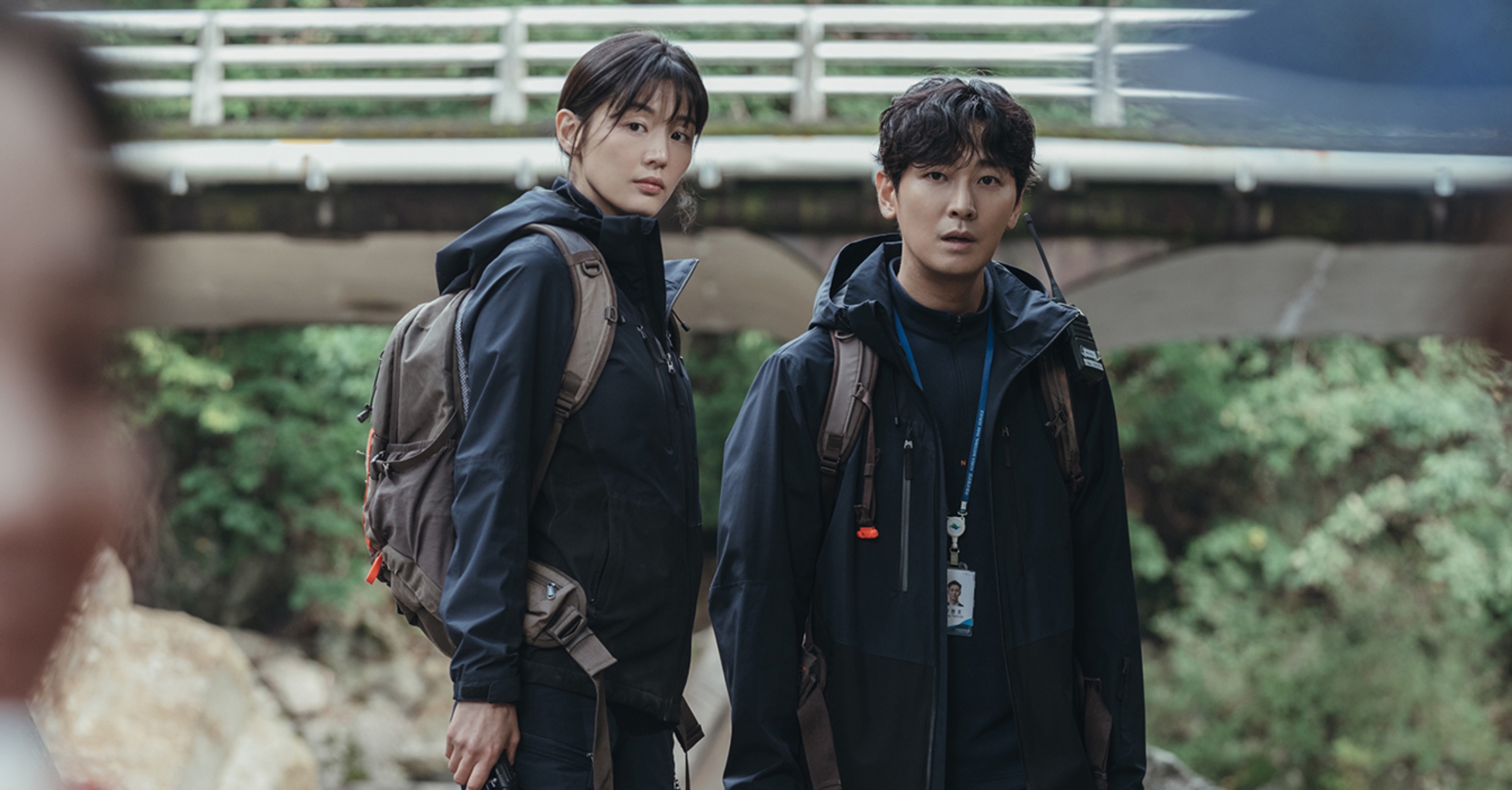 Actors Jun Ji-hyun and Ju Ji-hoon for 'Jirisan' K-drama wearing mountain gear and clothing.