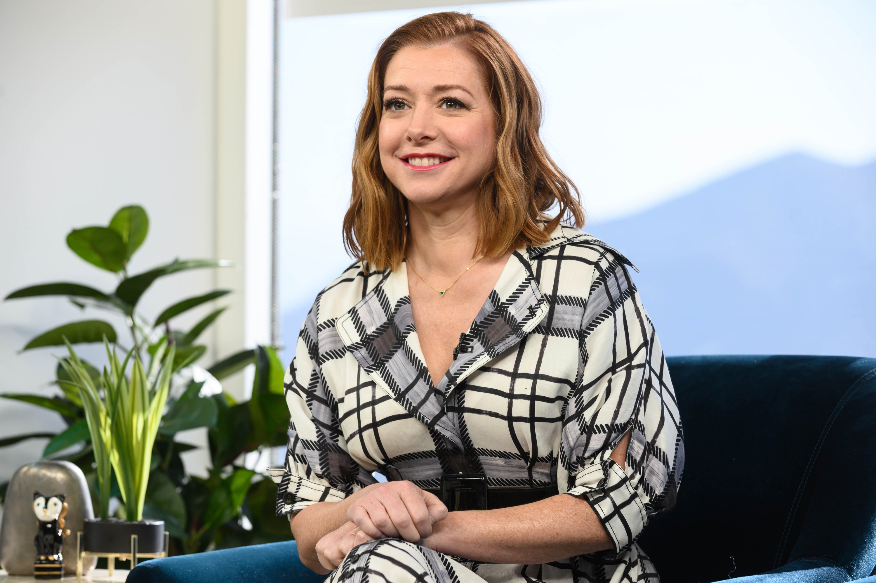 Actor Alyson Hannigan wears a black and white plaid dress. Hannigan's house was used to film scenes for 'This Is Us' Season 6.