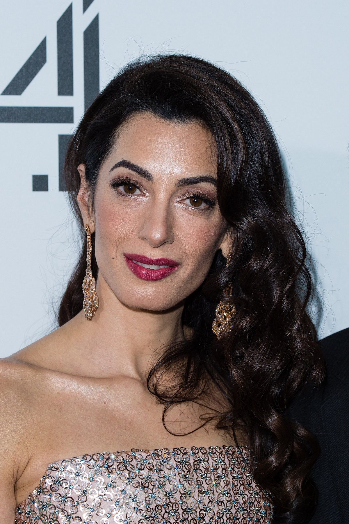 Close-up of Amal Clooney's face smiling for the camera.