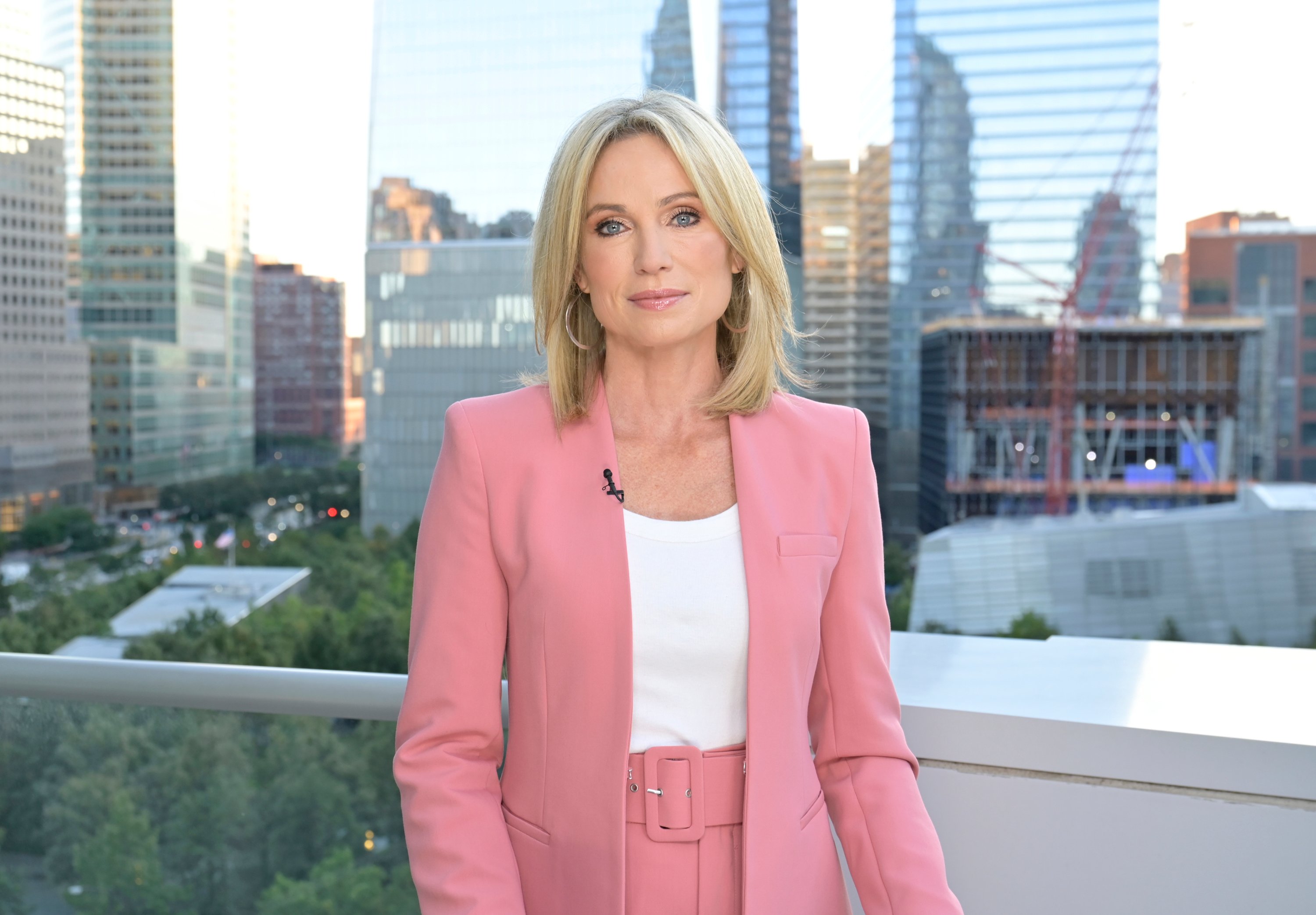 Amy Robach in a pink blazer and white top reports live from One World Trade Center in lower Manhattan as part of ABC News coverage