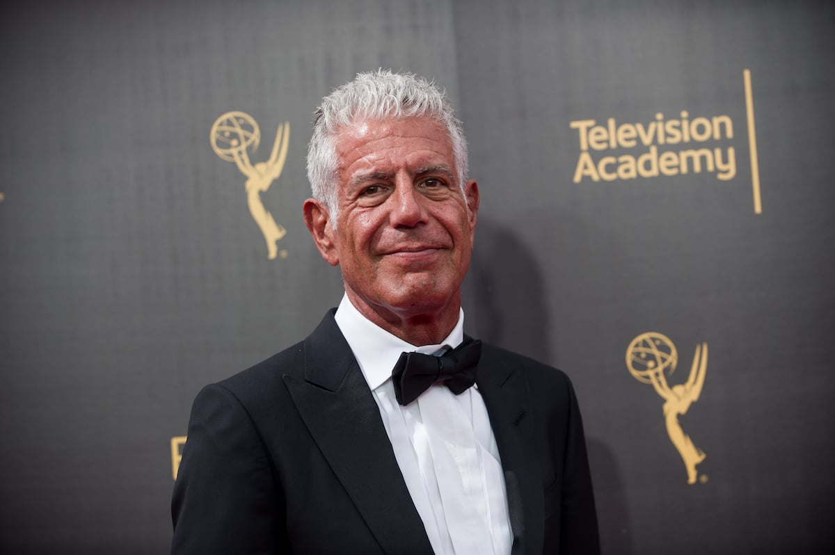 Anthony Bourdain smiling in front of a black background