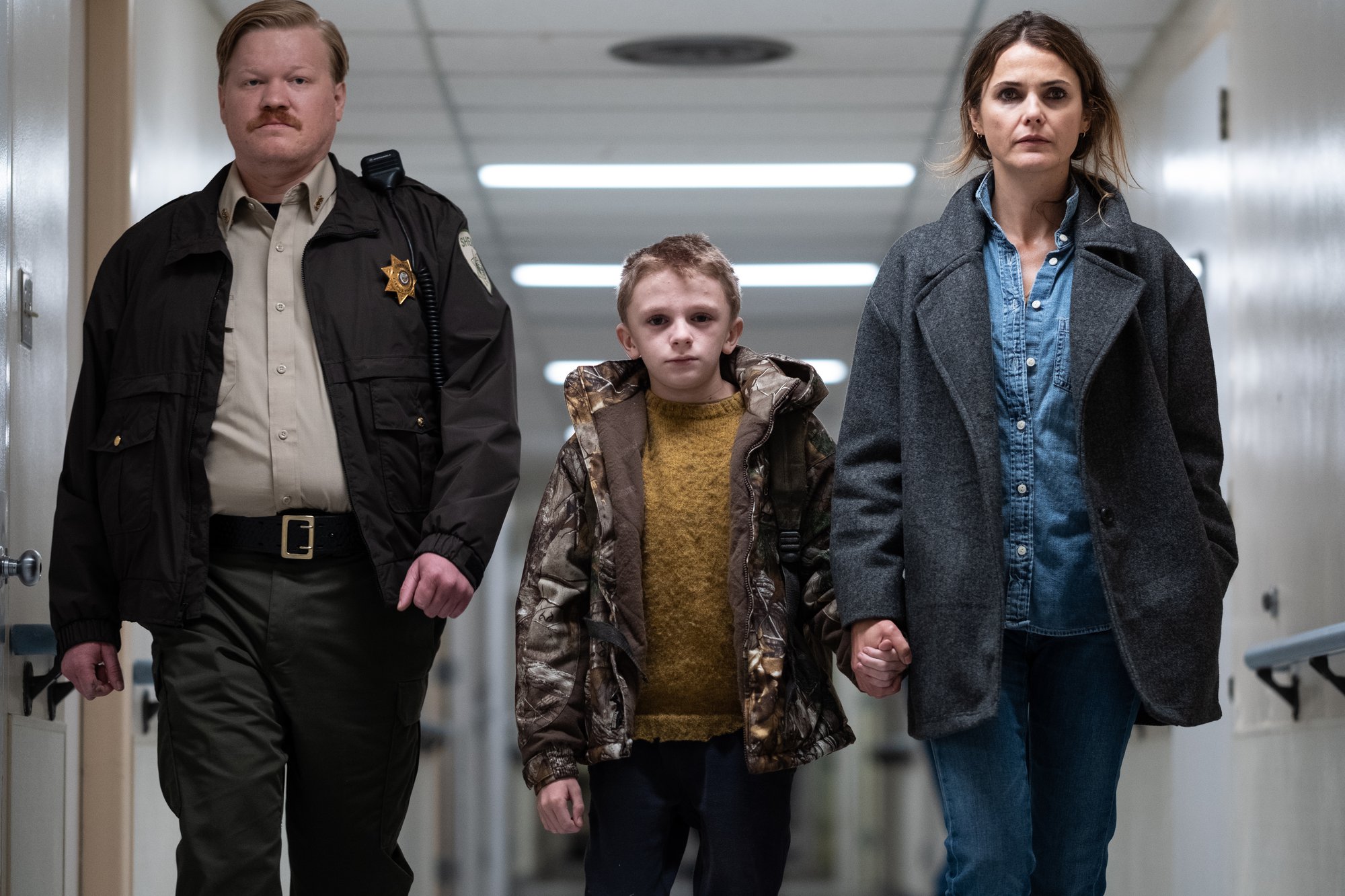 'Antlers' stars Jesse Plemons, Jeremy T. Thomas, and Keri Russell walking down a hallway in the hospital