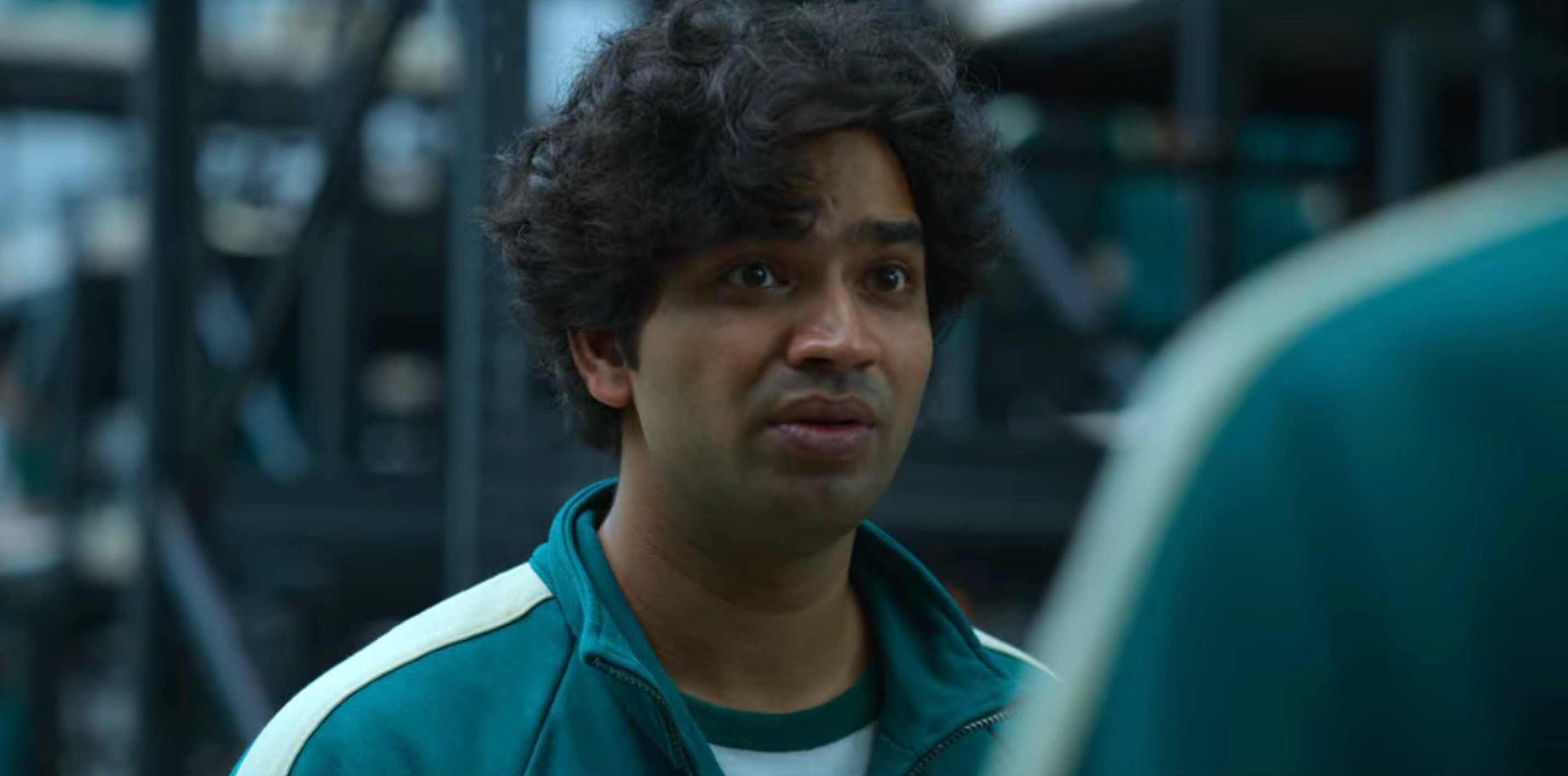 Anupam Tripathi as Ali Abdul for Netflix's 'Squid Game' wearing green tracksuit.