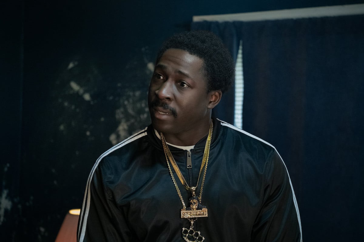 Eric Kofi-Abrefa  wearing a track jacket and gold chains as Lamar on 'BMF"