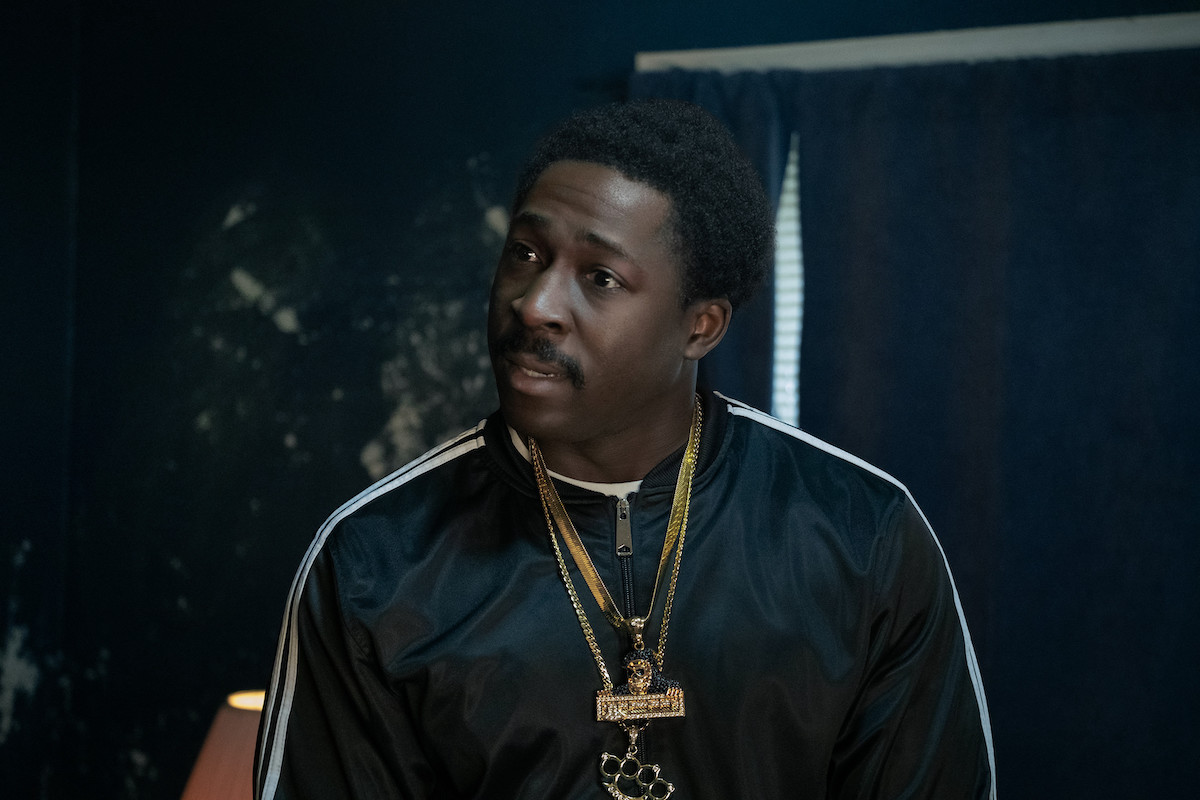 Eric Kofi-Abrefa wearing a track jacket and gold chains as Lamar on 'BMF"