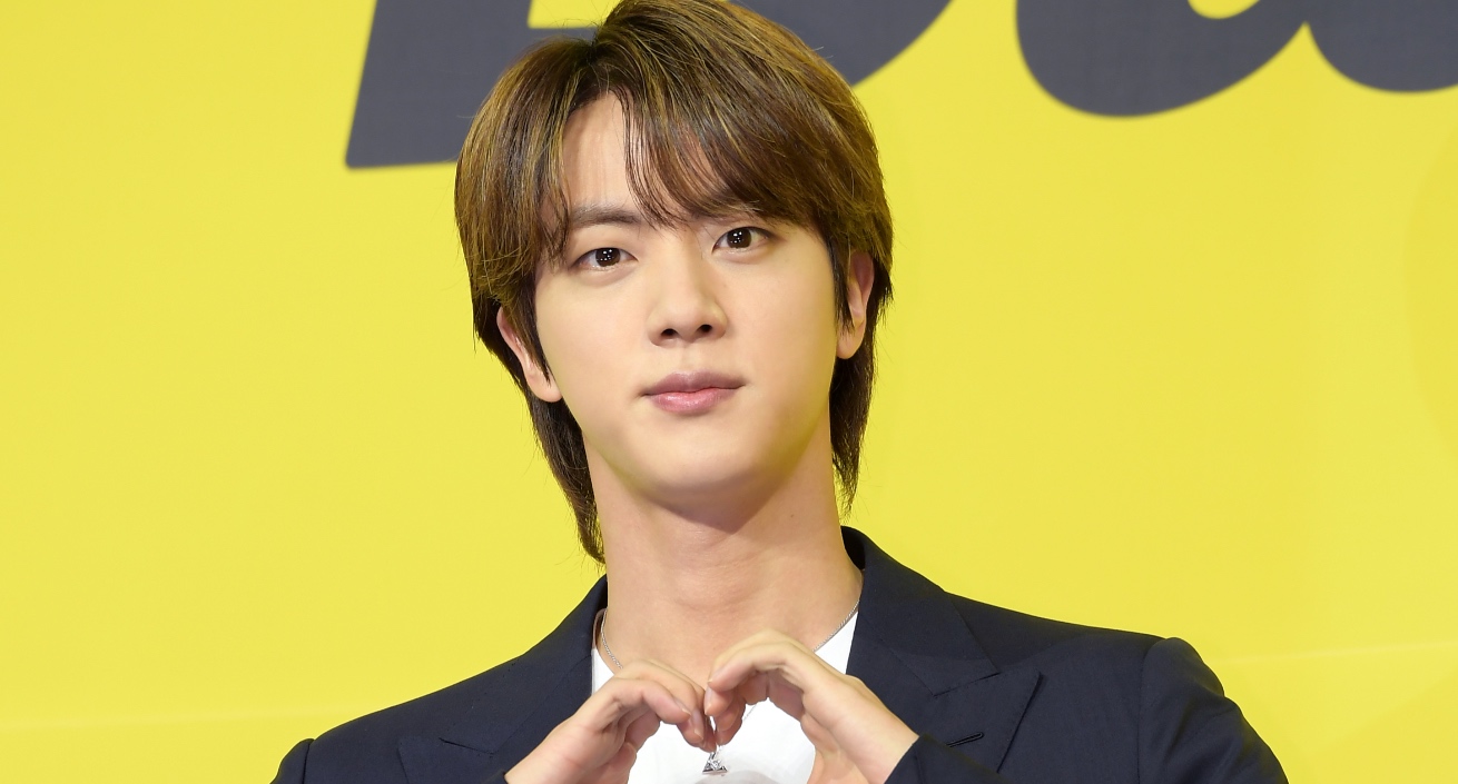 BTS Jin for 'Jirisan' K-drama for iQiyi in front of 'Butter' banner doing heart hands