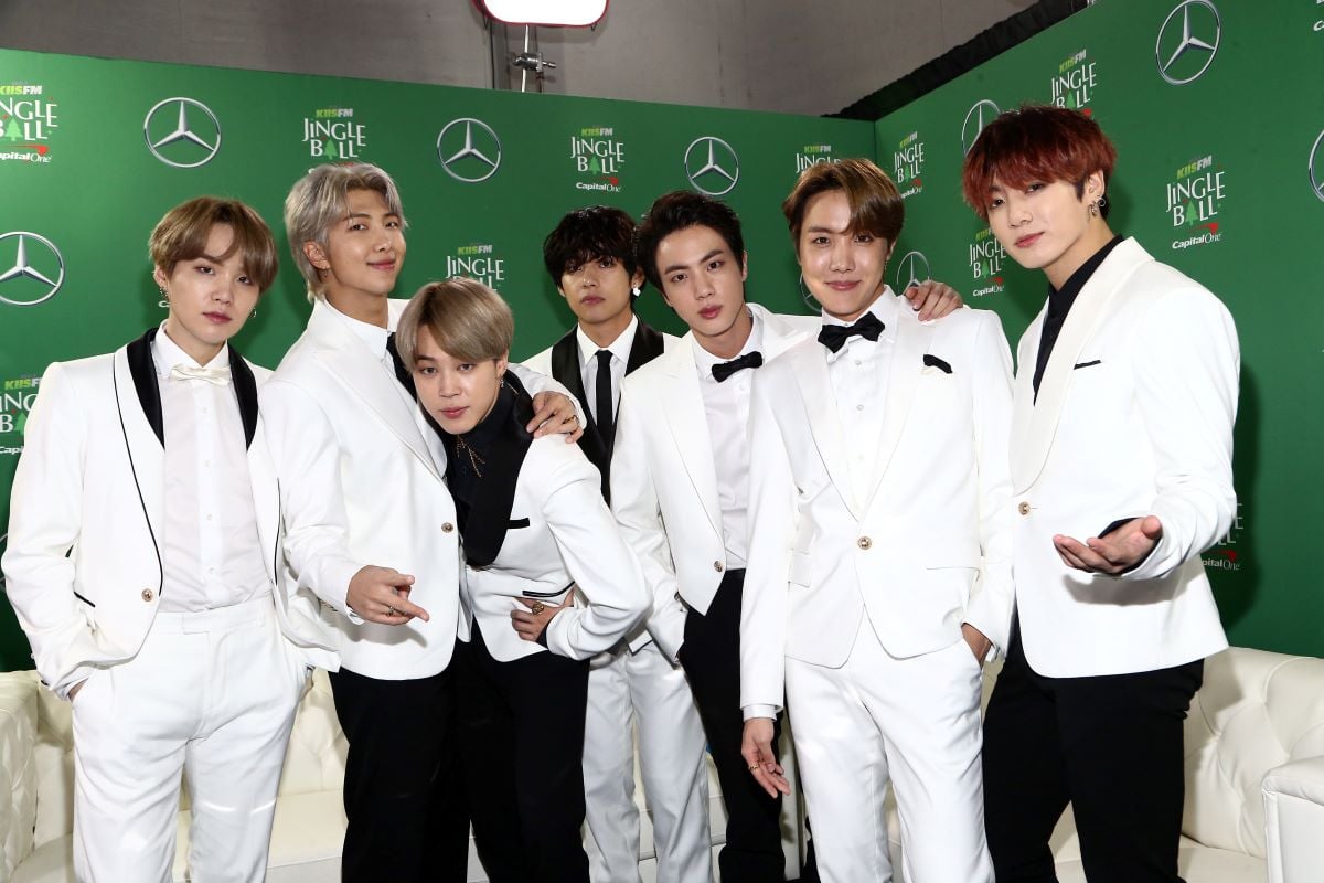 BTS stand in a line in black and white suits