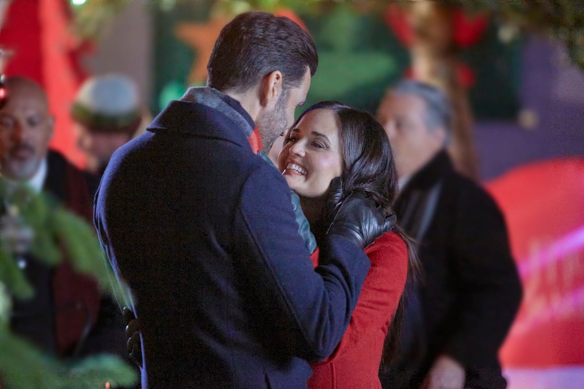 Benjamin Ayres leans in to kiss Danica McKellar in 'You, Me & The Christmas Trees'