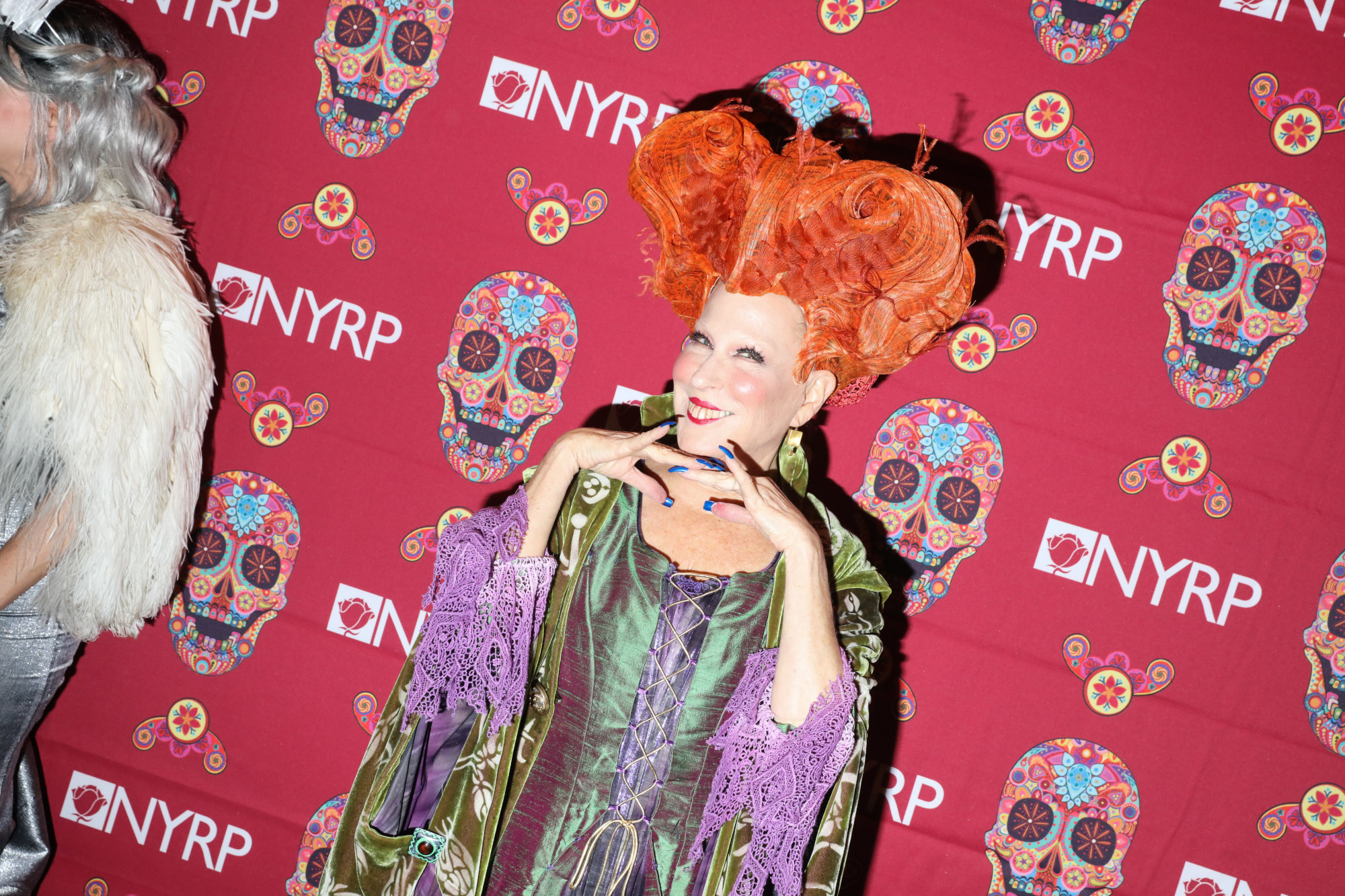 Bette Midler dressed as Winifred Sanderson from 'Hocus Pocus.' She's returning for 'Hocus Pocus 2' on Disney+. In the photo, she's wearing the witch's orange wig and green and purple dress. She's 1 of 3 witches in the cast of 'Hocus Pocus.'