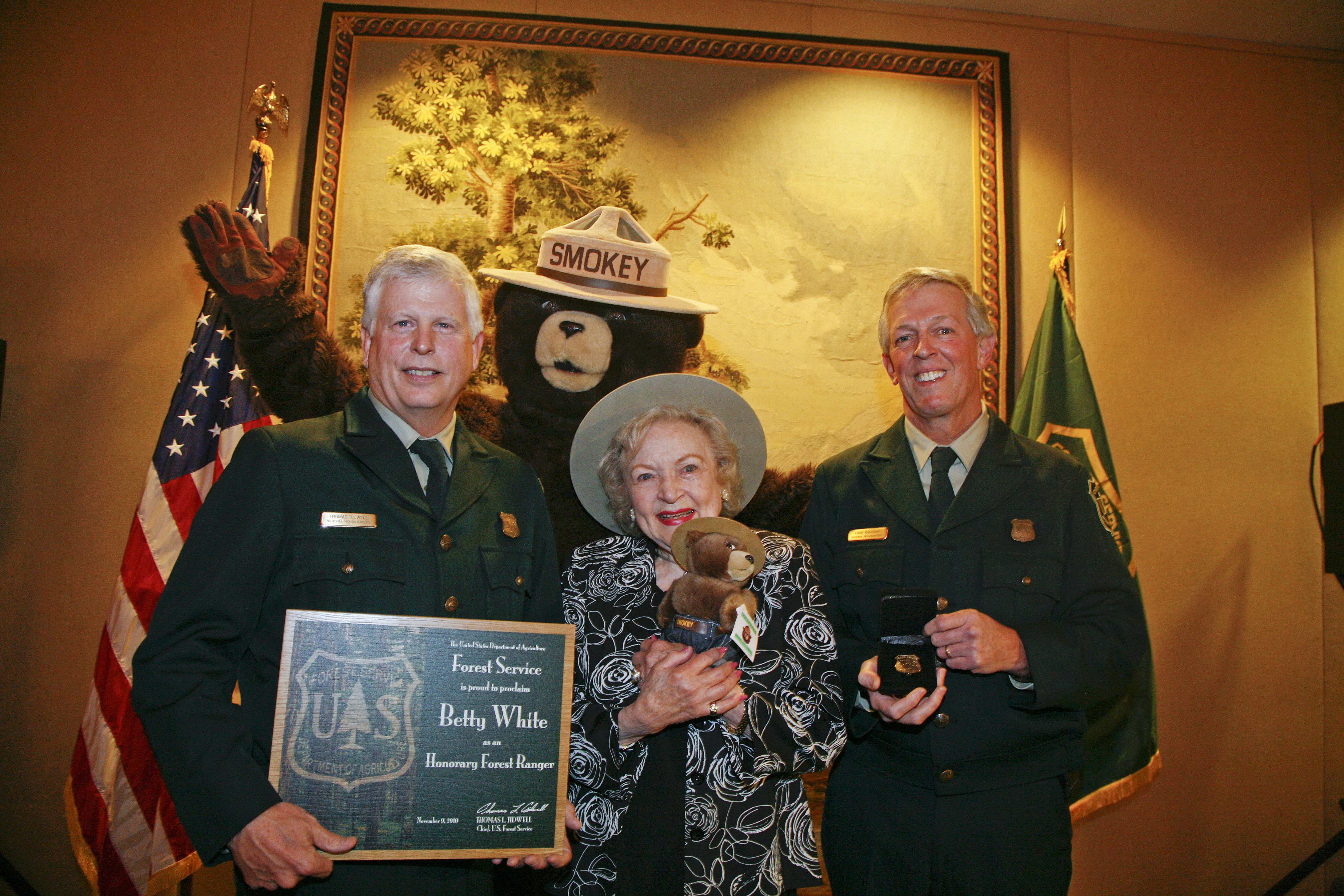 Betty White stands with members of the Forest Service duringa 2010 ceremony to name her an honorary forest ranger