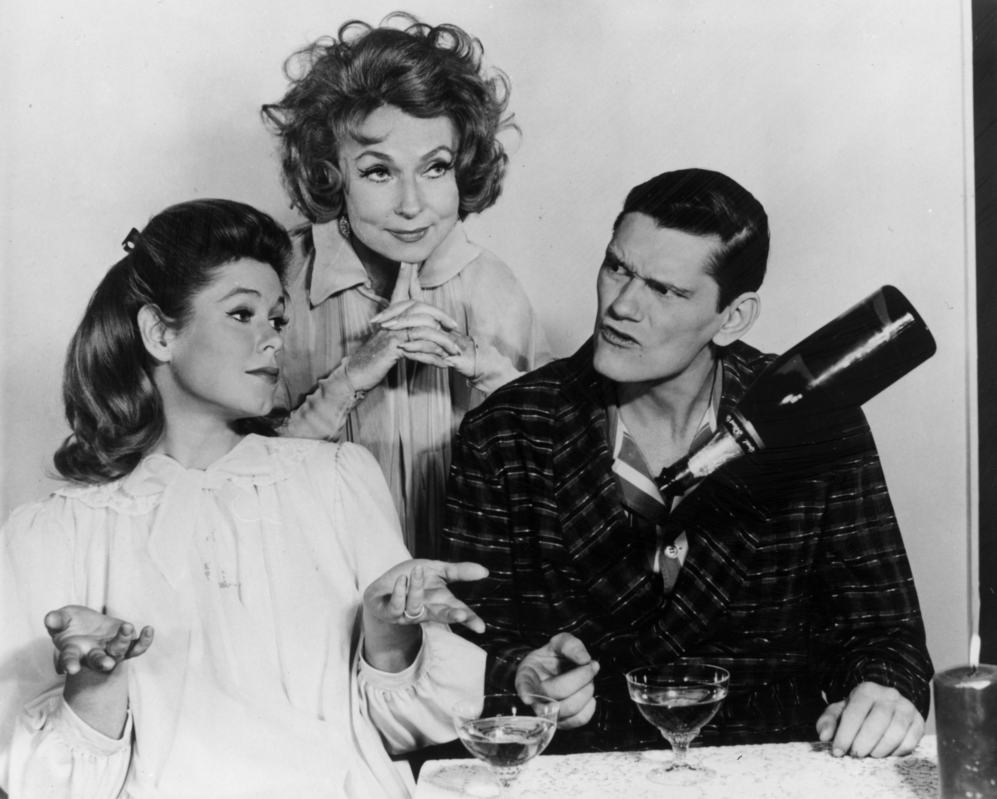 'Bewitched' actor Elizabeth Montgomery in a nightgown, Agnes Morehead in a witch outfit, and Dick York in a robe in a scene from the ABC sitcom.