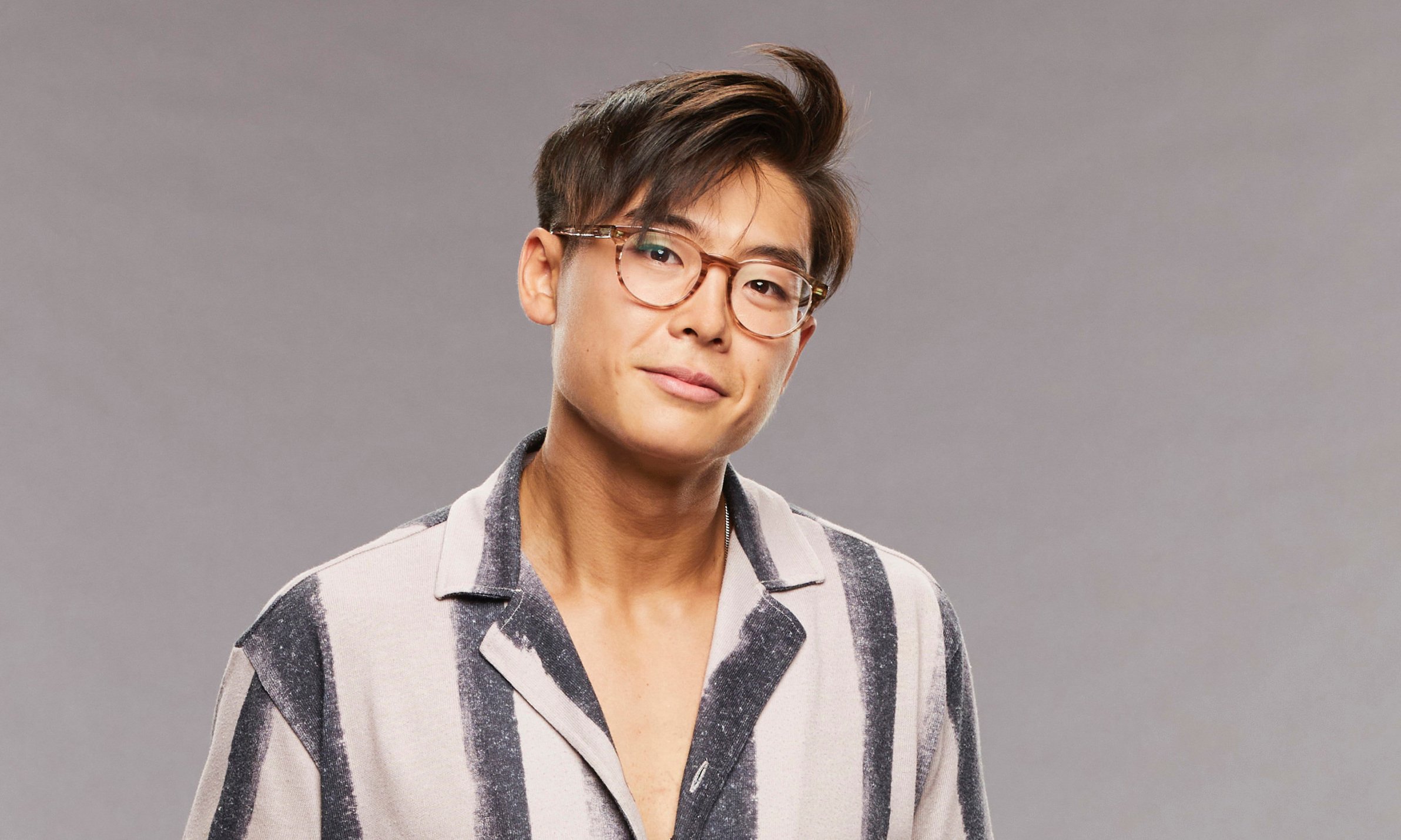 Derek Xiao of 'Big Brother 23' poses in a stripped shirt.