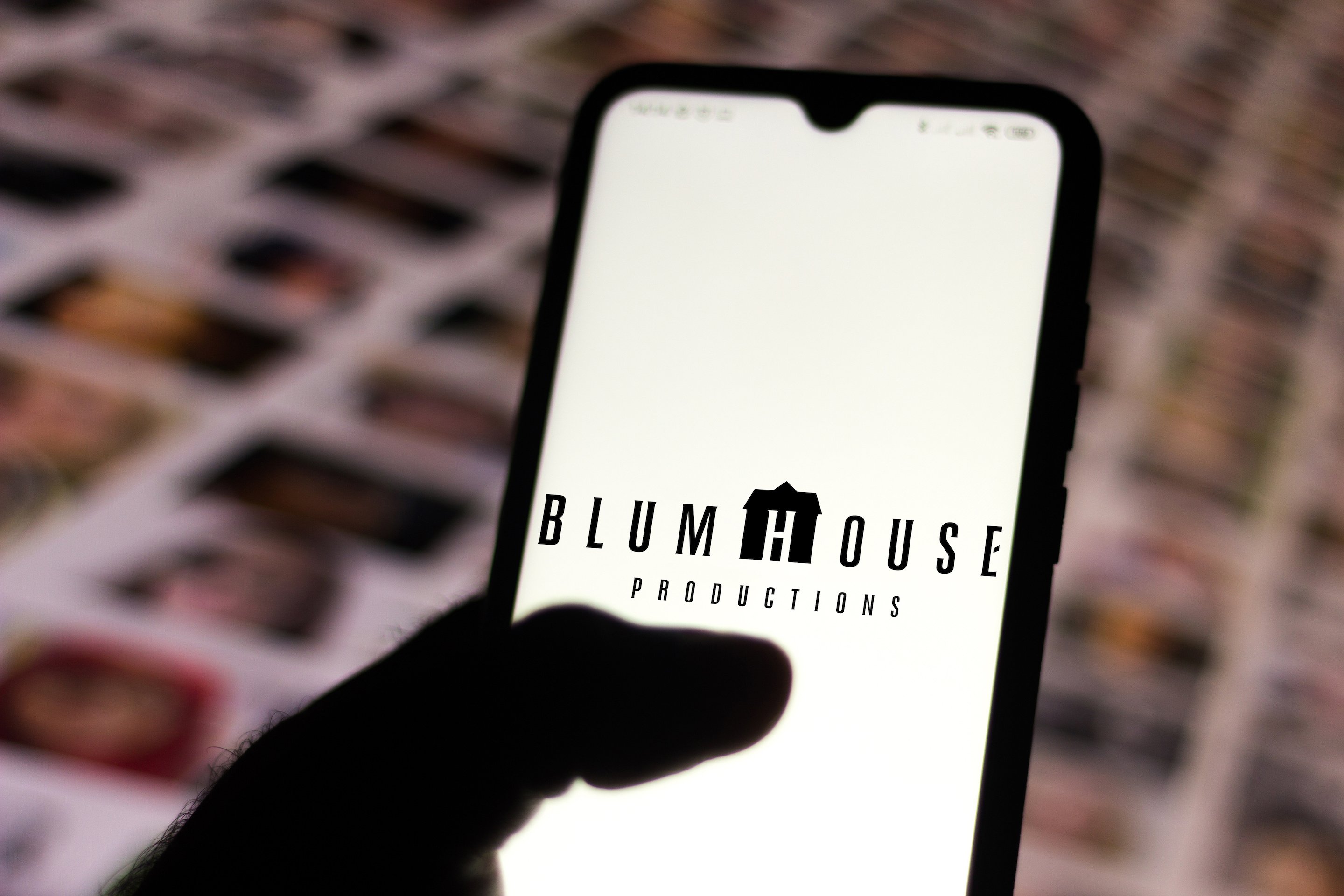 Blumhouse Productions, home of The Manor movie, logo appears on a phone screen