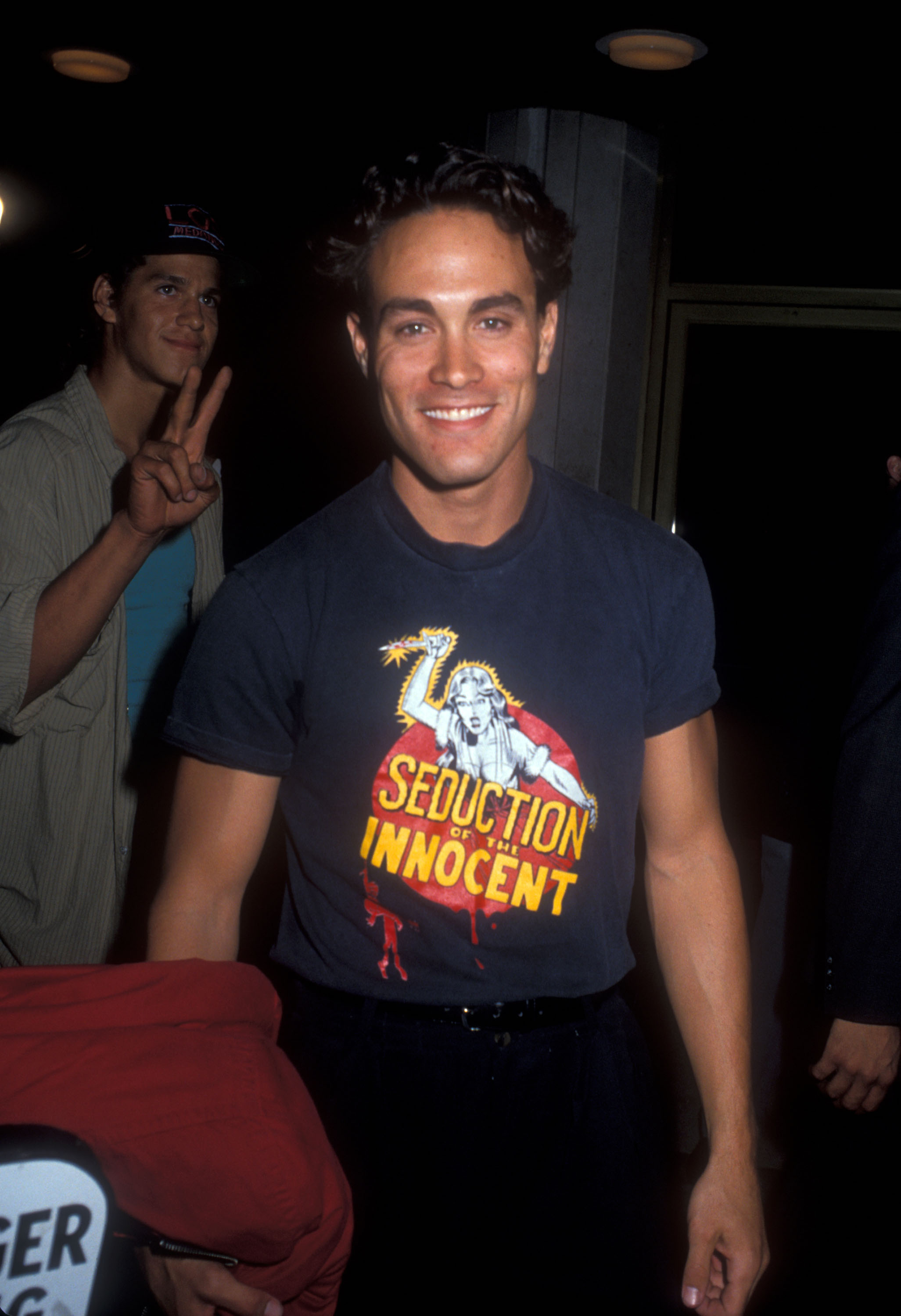 Brandon Lee, Bruce Lee's son, smiling at a premiere. Brandon Lee's net worth was around $5 million at the time of his death.
