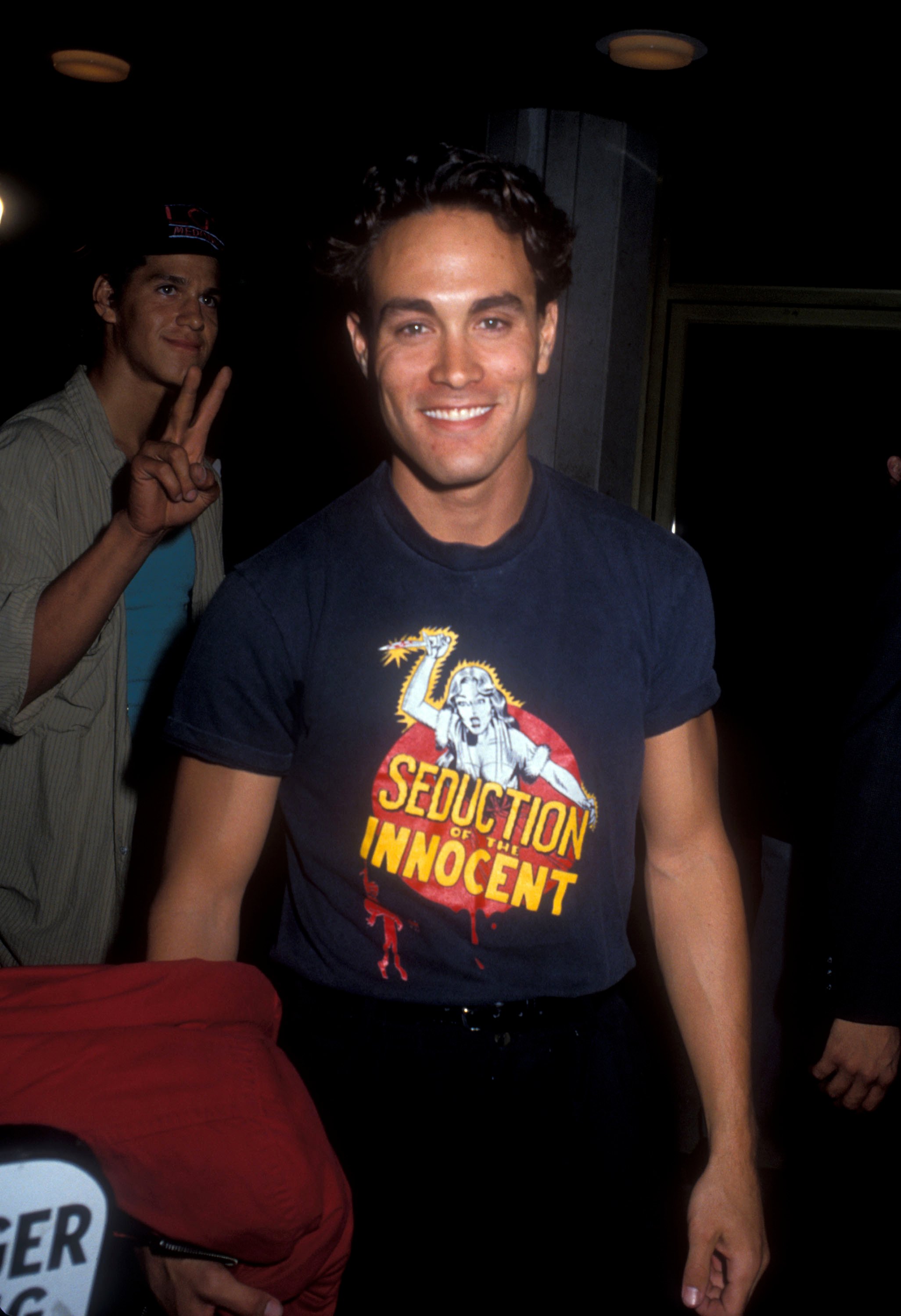 Brandon Lee, Bruce Lee's son, smiling at a premiere. Brandon Lee's net worth was around $5 million at the time of his death.