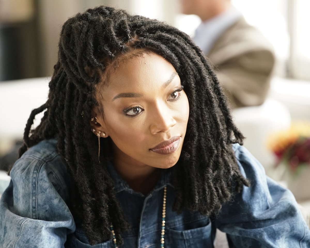 Brandy as Naomi wearing locs and a blue denim shirt on 'Queens'