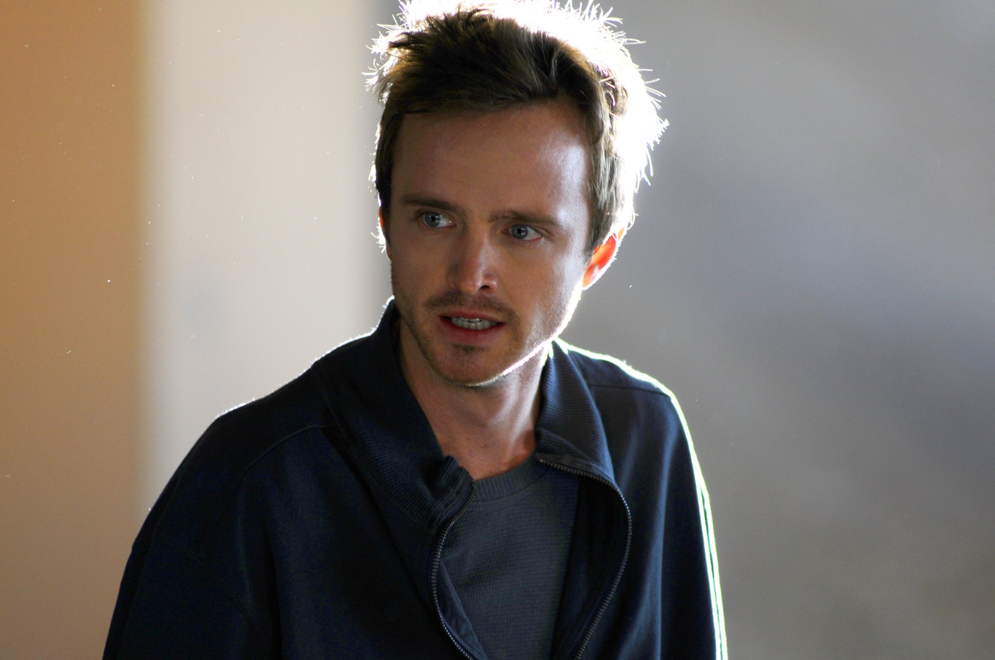 Aaron Paul as Jesse Pinkman in AMC's 'Breaking Bad' Season 3. His hair is messy and he looks scared or confused.