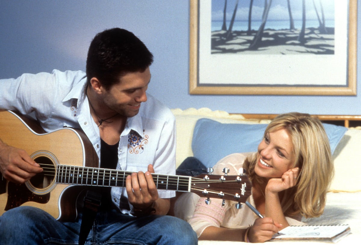 Britney Spears and Anson Mount with guitar on couch in Crossroads