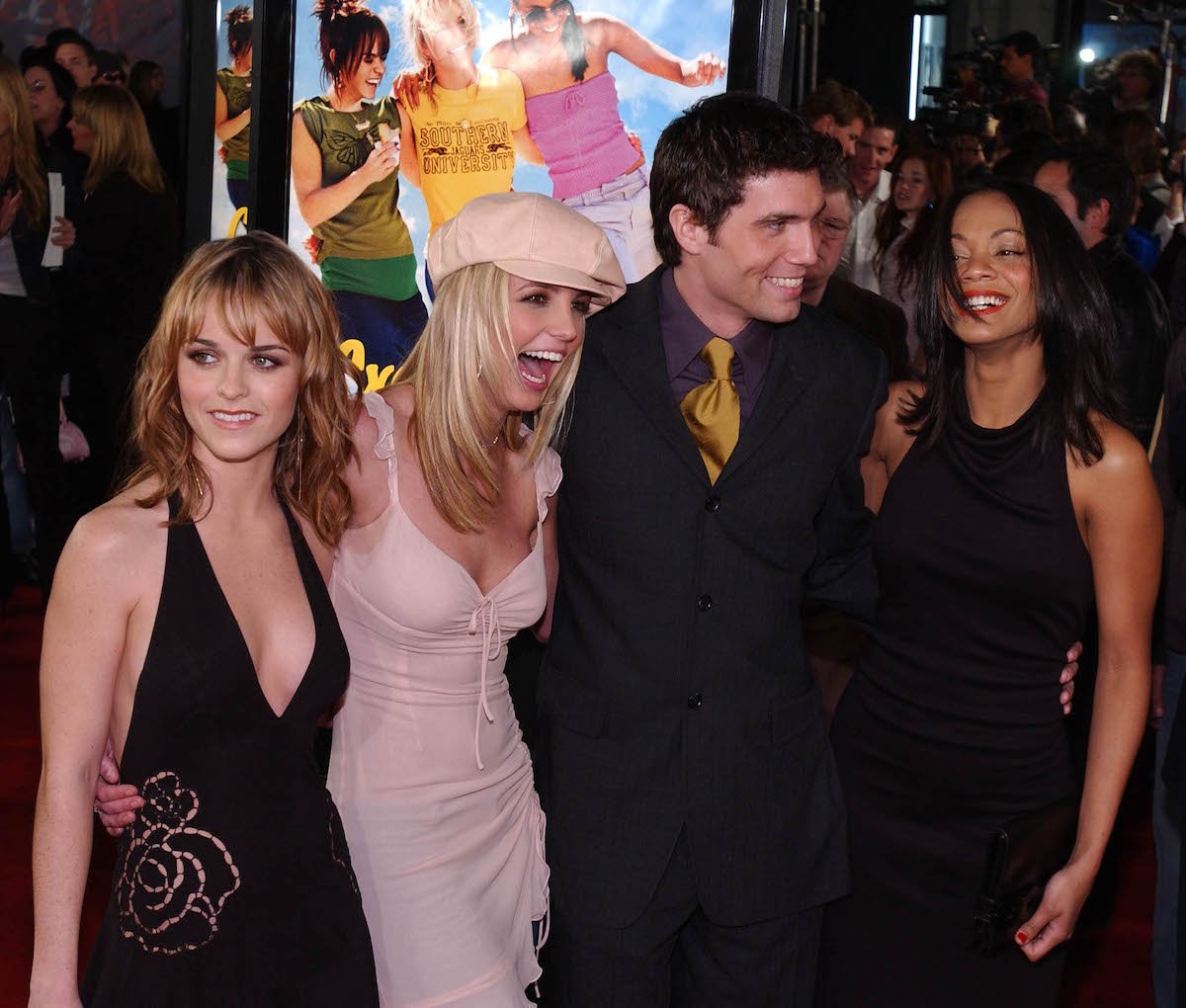 Britney Spears with 'Crossroads' cast members Taryn Manning, Anson Mount, and Zoe Saldana all posing together at a movie event