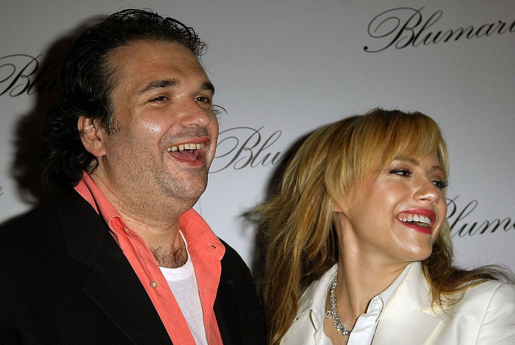 Simon Monjack and Brittany Murphy laugh together on the red carpet.
