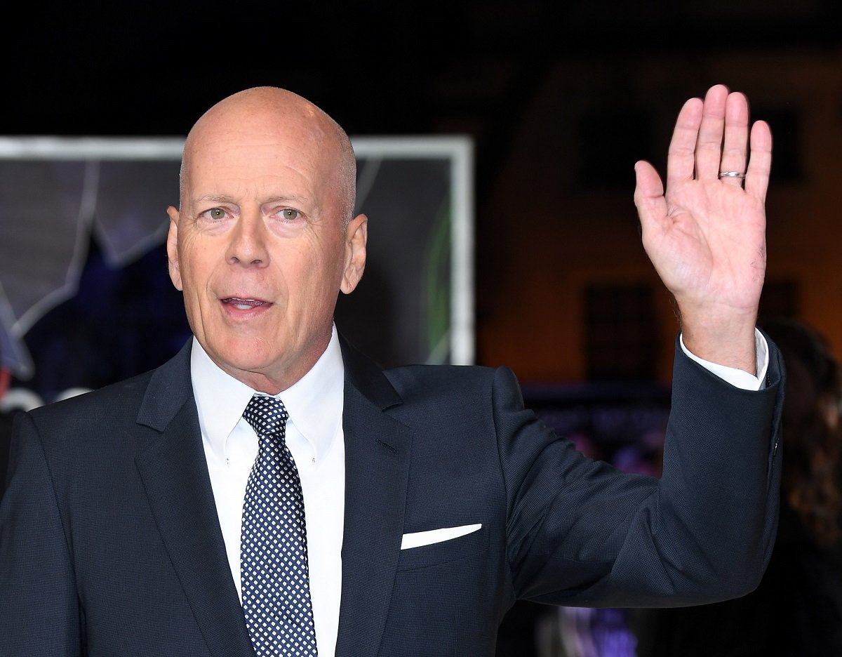 Bruce Willis raising his hand