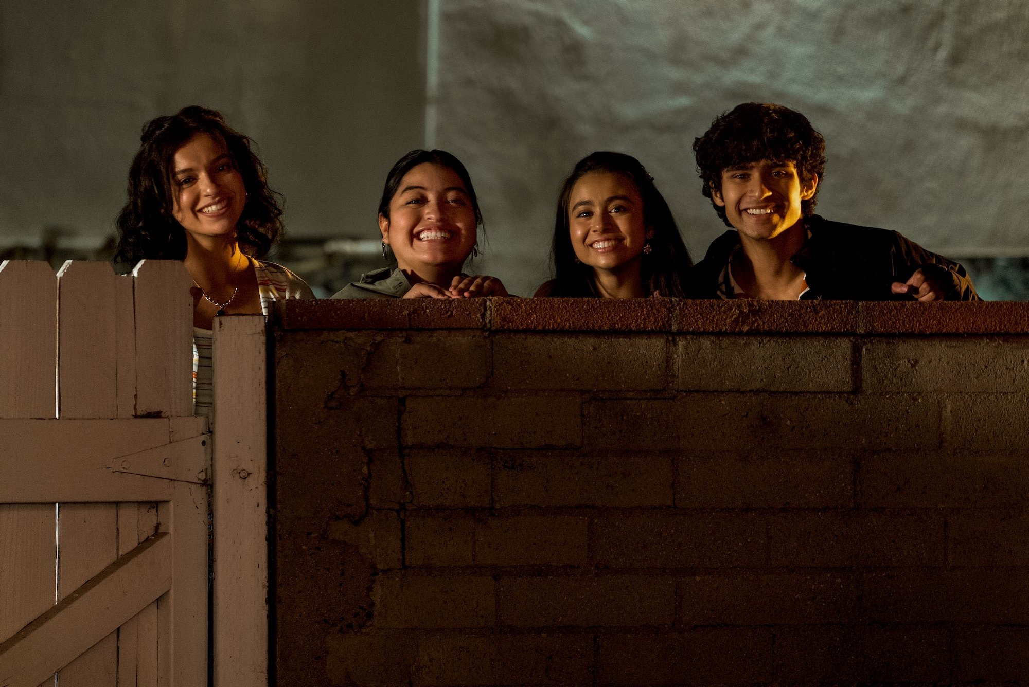 Bryana Salaz, Keyla Monterroso Mejia, Ciara Riley Wilson, and Shiv Pai standing on a wall in 'On My Block' Season 4.