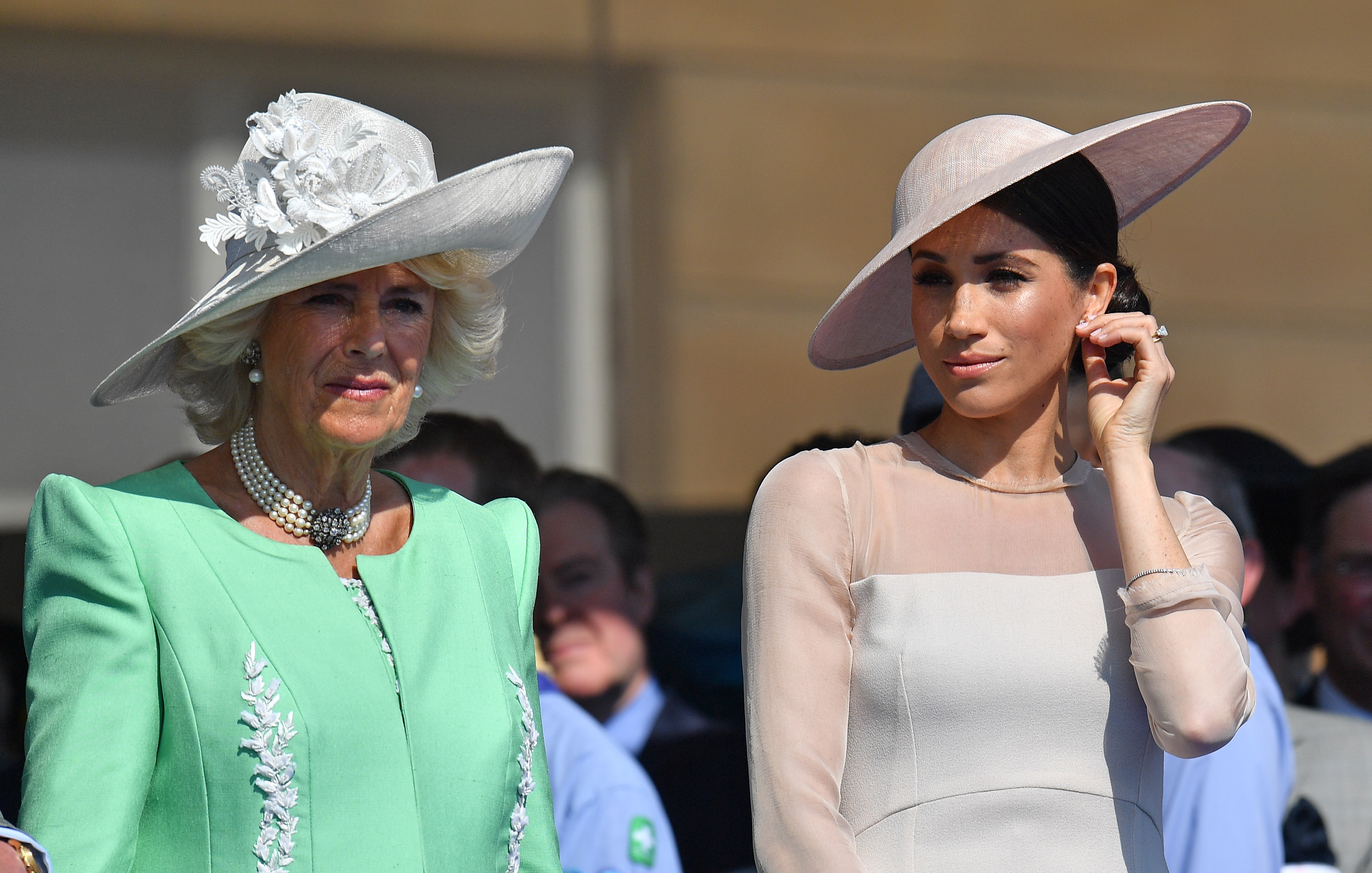 Camilla Parker Bowles and Meghan Markle standing side-by-side at Prince Charles 70th Birthday Celebration